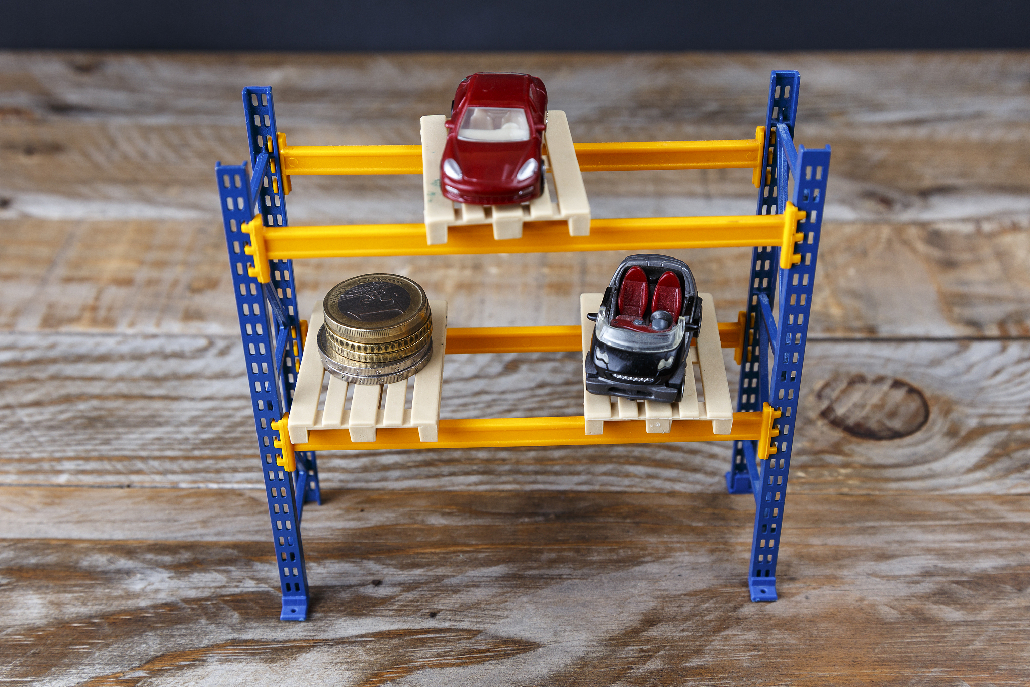 two miniature cars and some coins