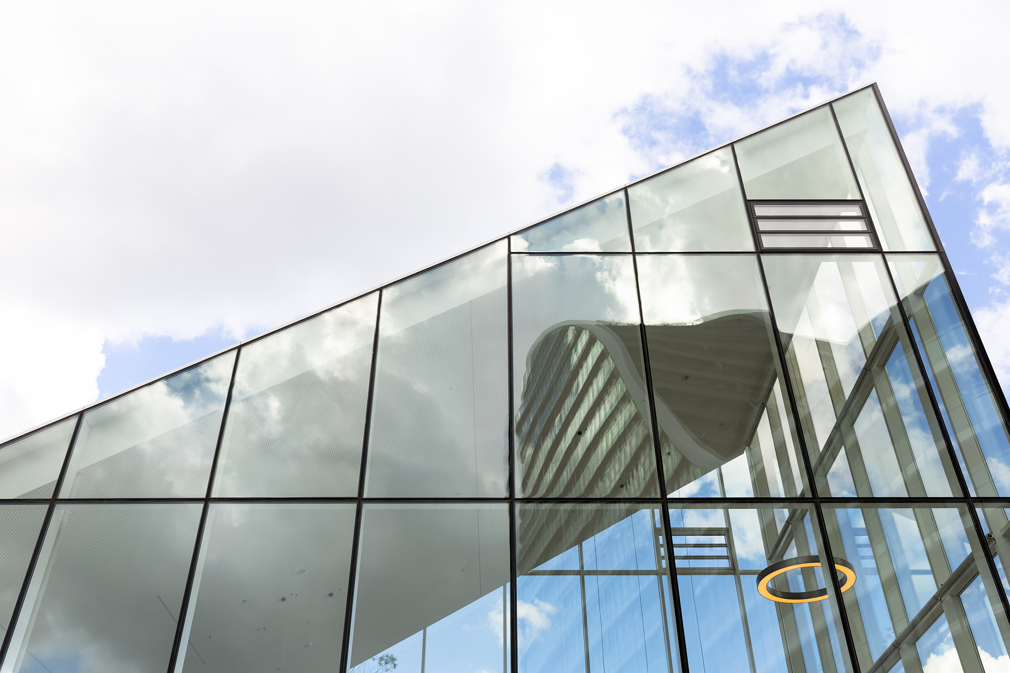 low angle view of modern glass office building with reflection o