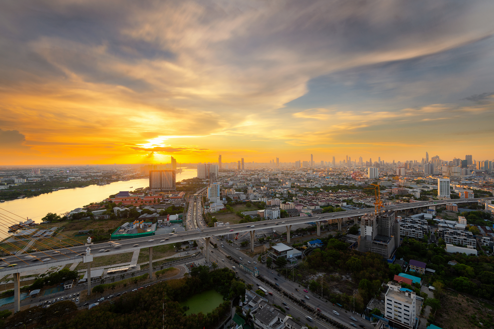 beautiful bridge in the cityscape under the colorful sunset sky 