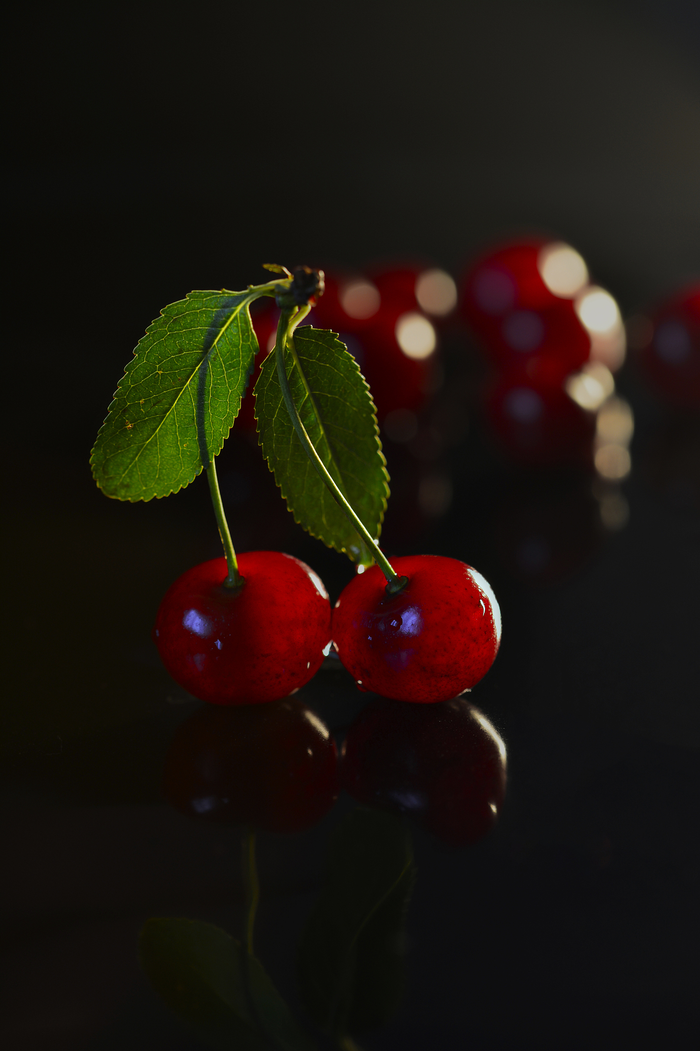two cherries on black background