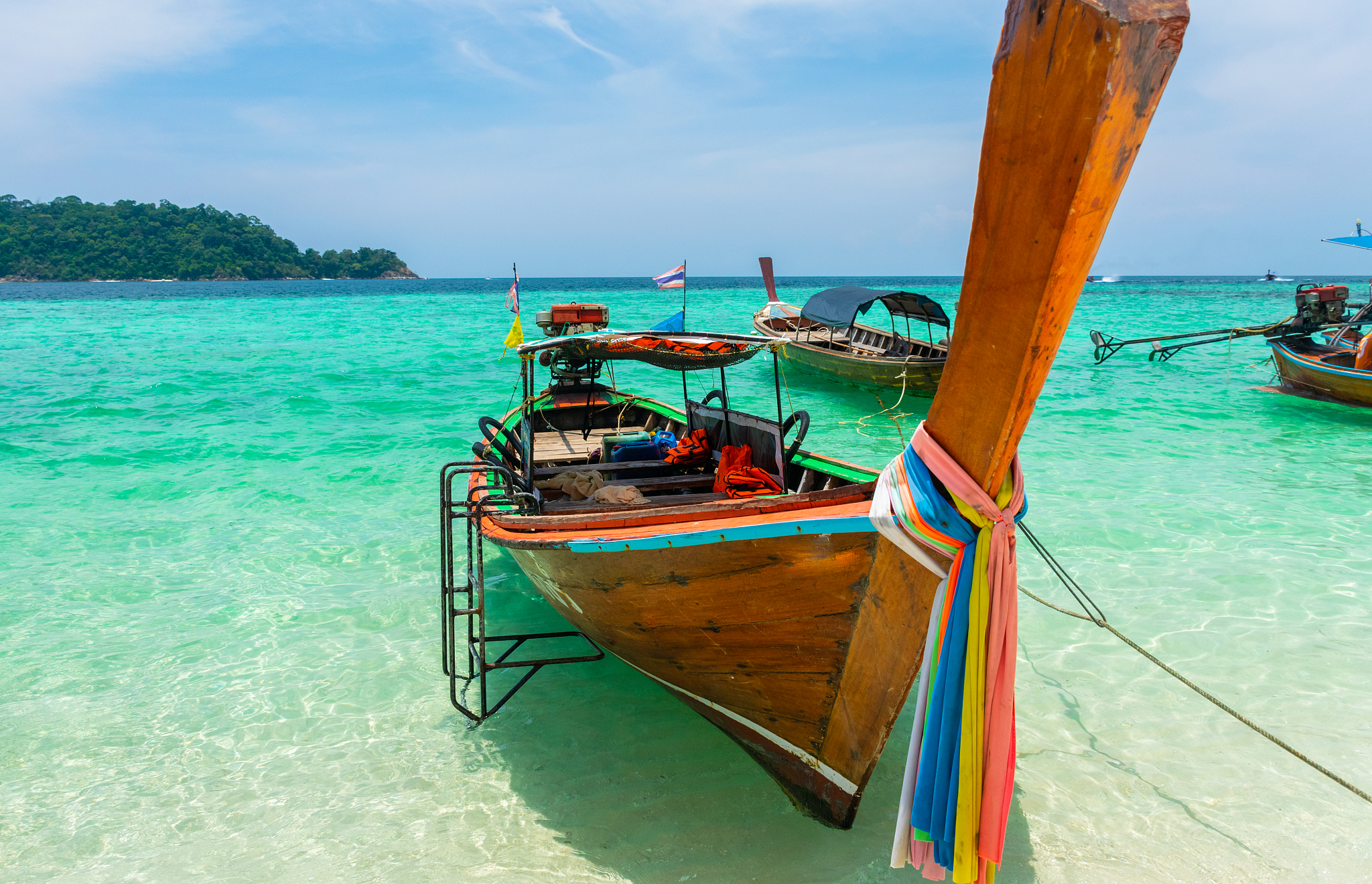 longtail boat moored on beach at koh lipe, thailand