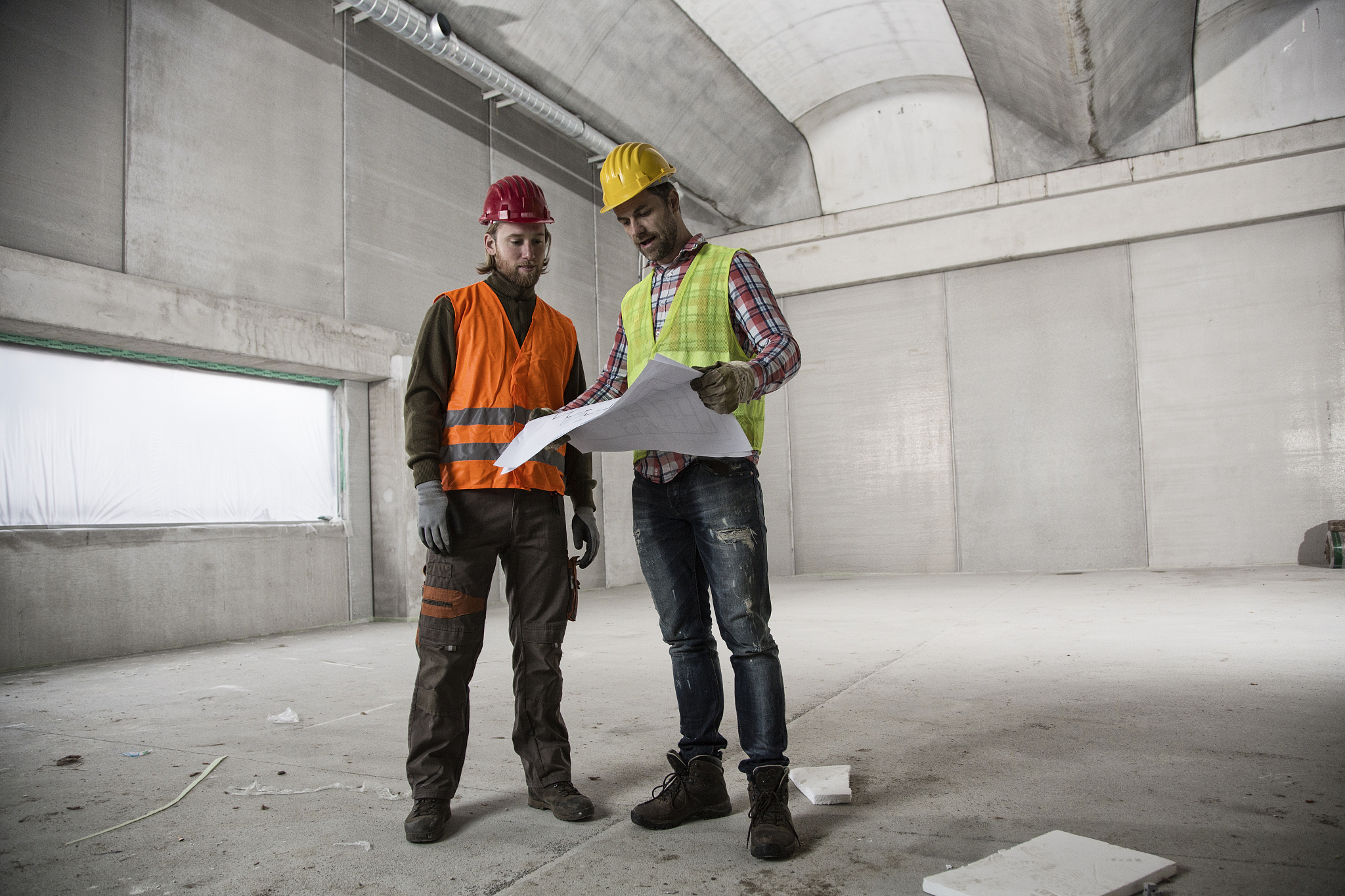 two construction workers with blueprints
