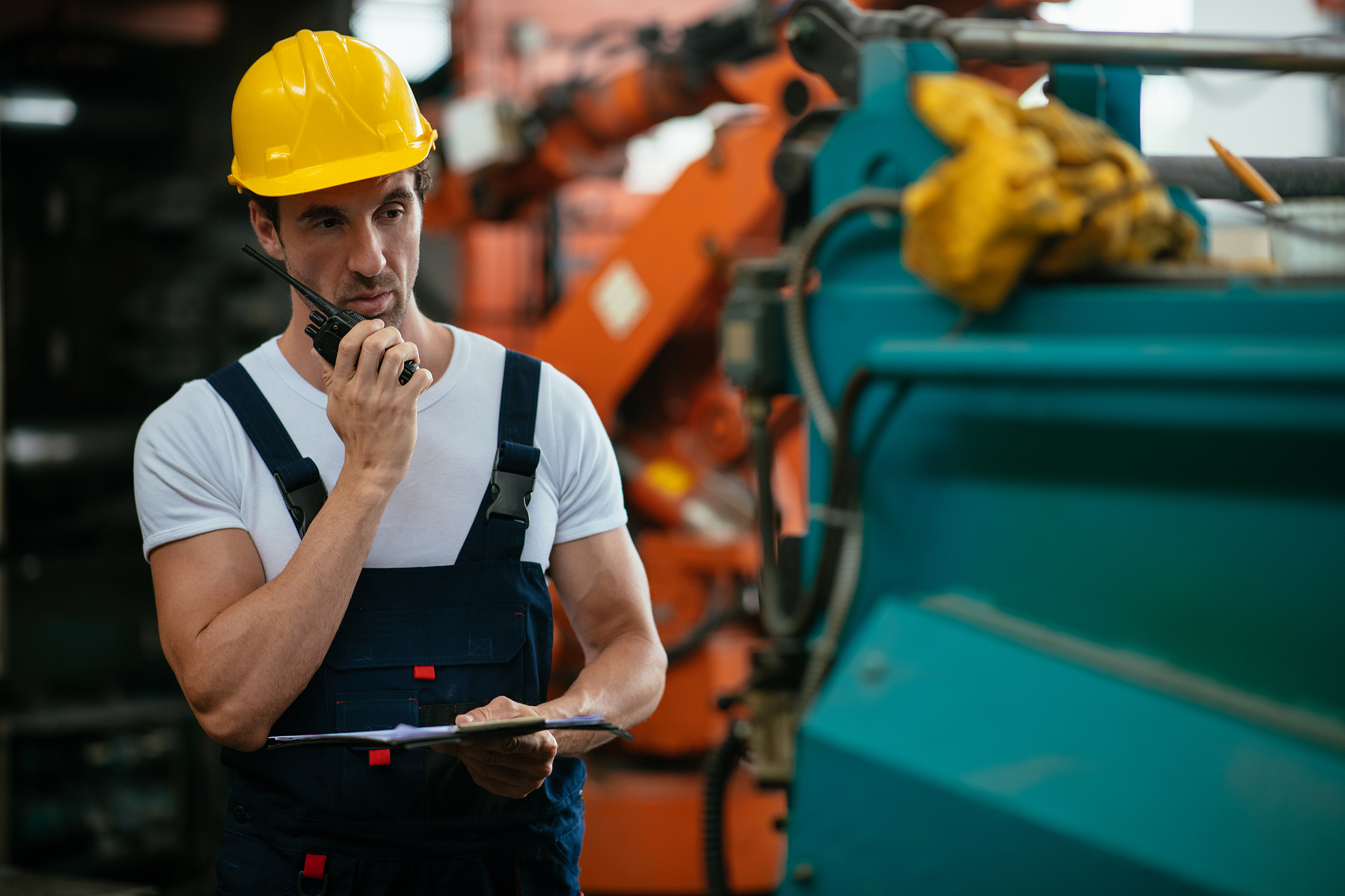 engineer in factory using walkie-talkie