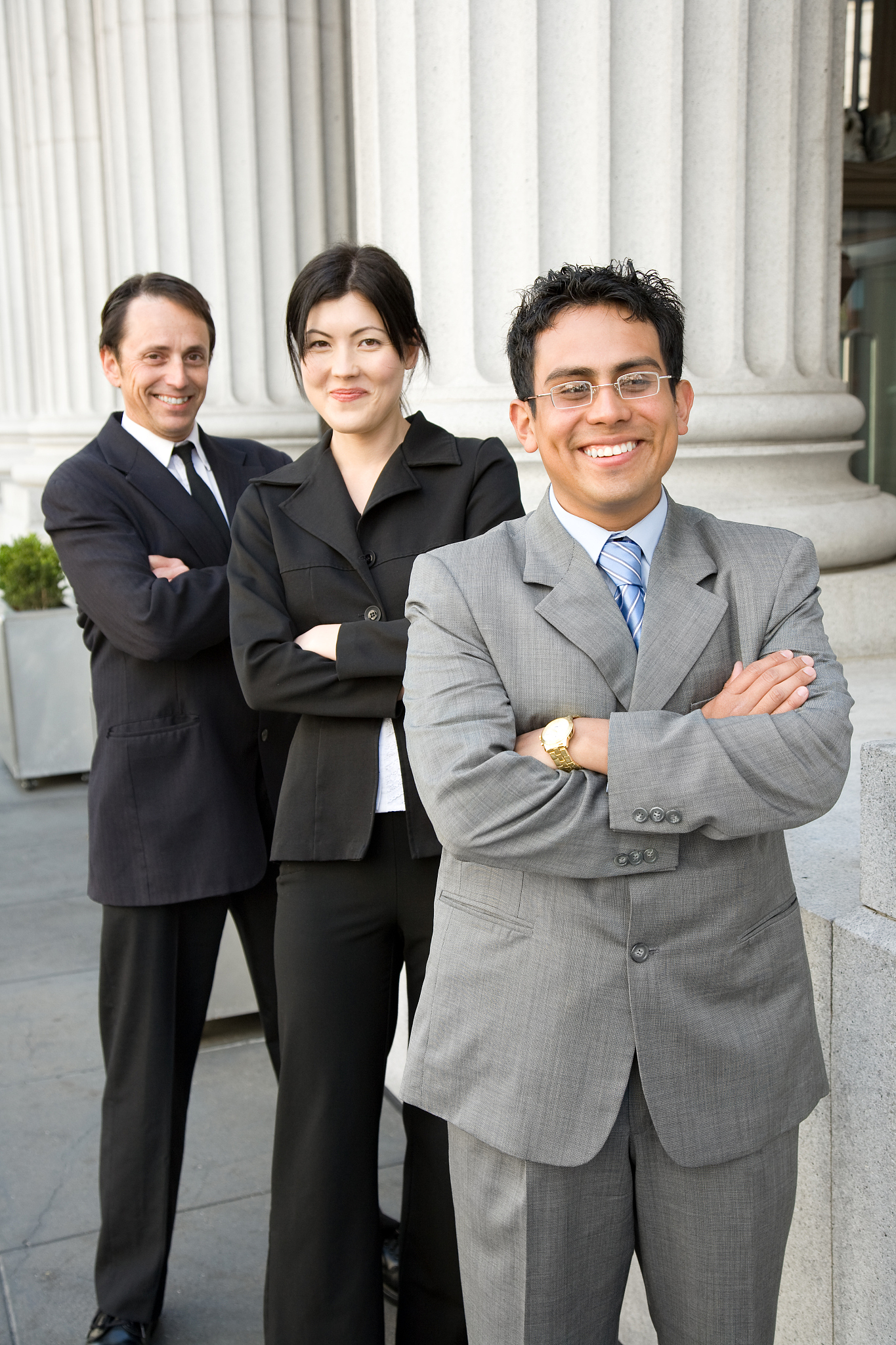 finance team in front of building - vertical