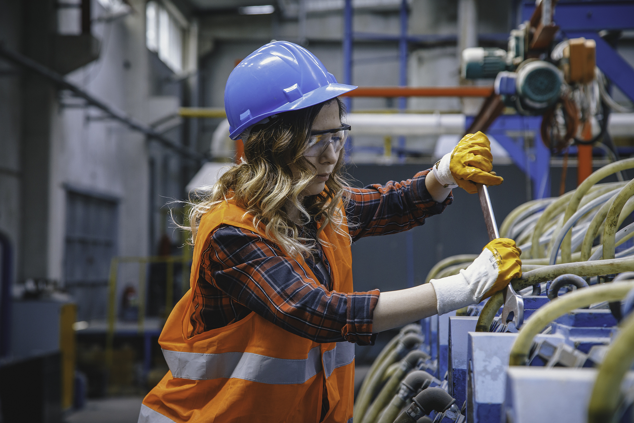 portrait of young manuel worker woman working with ball valves i