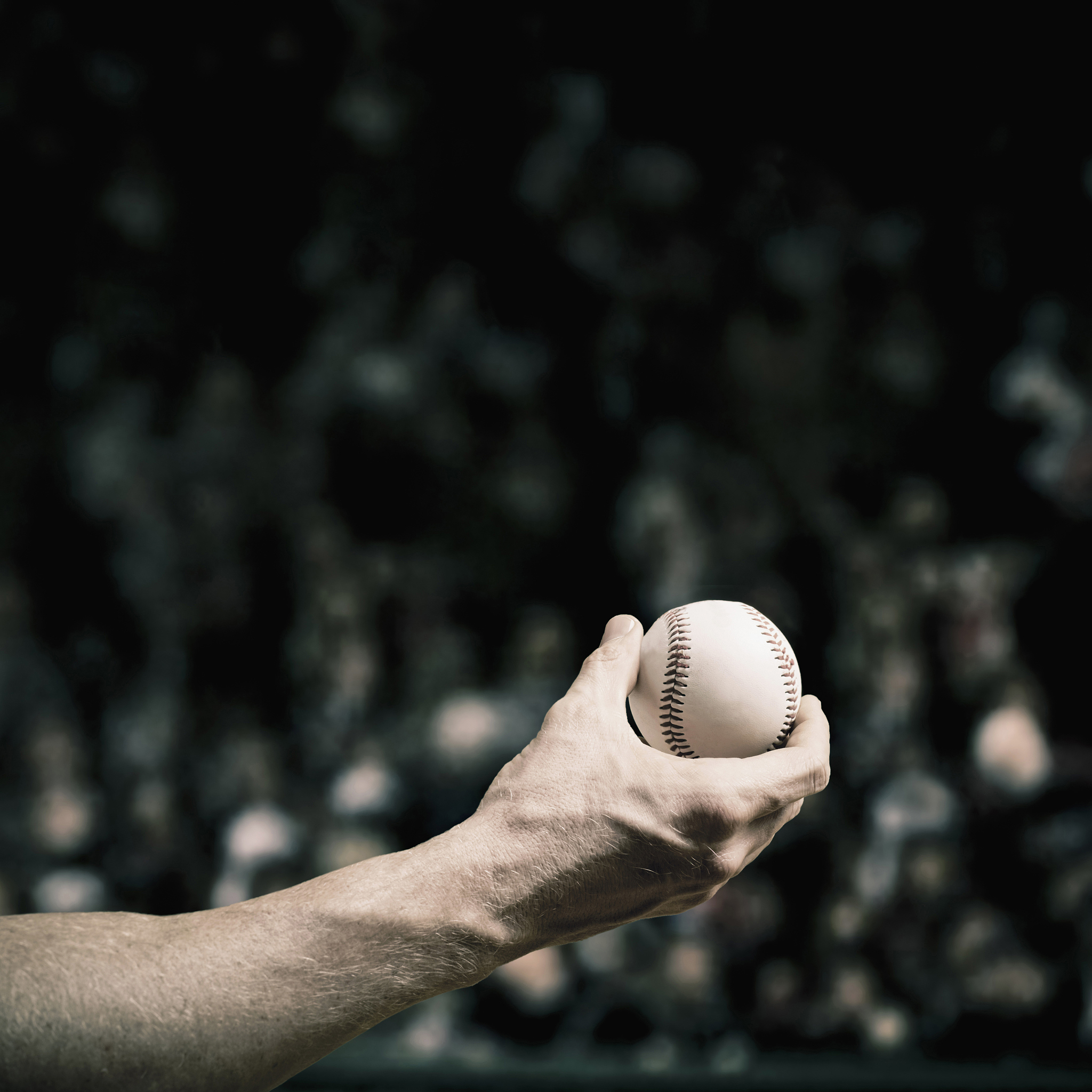 caucasian baseball player holding ball