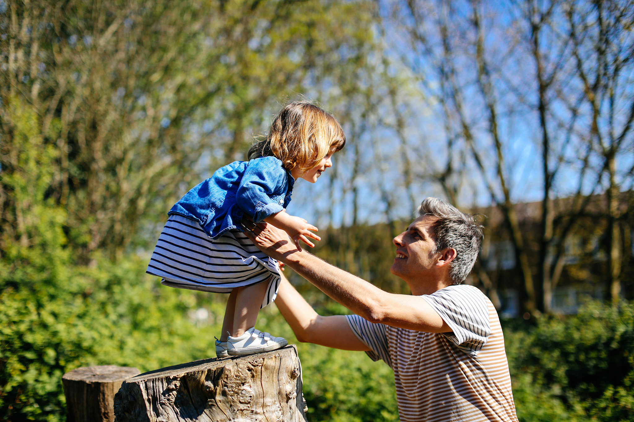 father and little girl enjoying nature walk