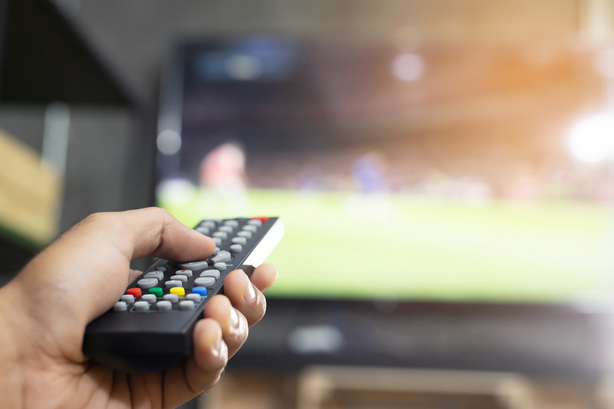 a man is watching a live broadcast of the world cup on tv at hom
