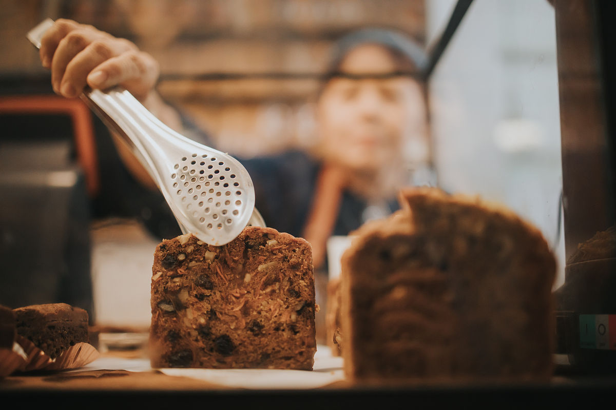 泰国活跃的妇女在咖啡馆<strong>兼职</strong>工作,同时购买面包房给顾客