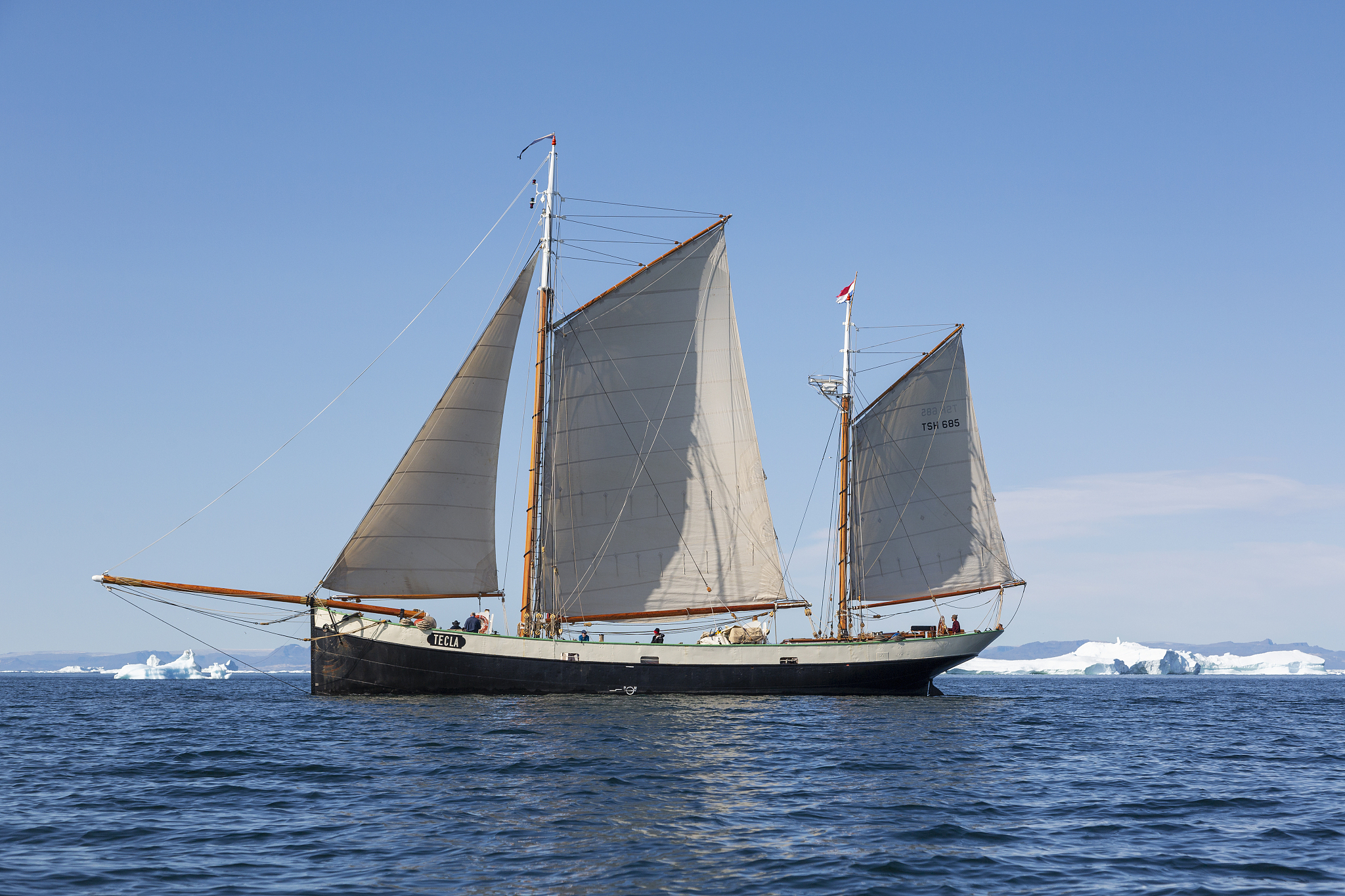 ship sailing on sunny arctic atlantic ocean greenland