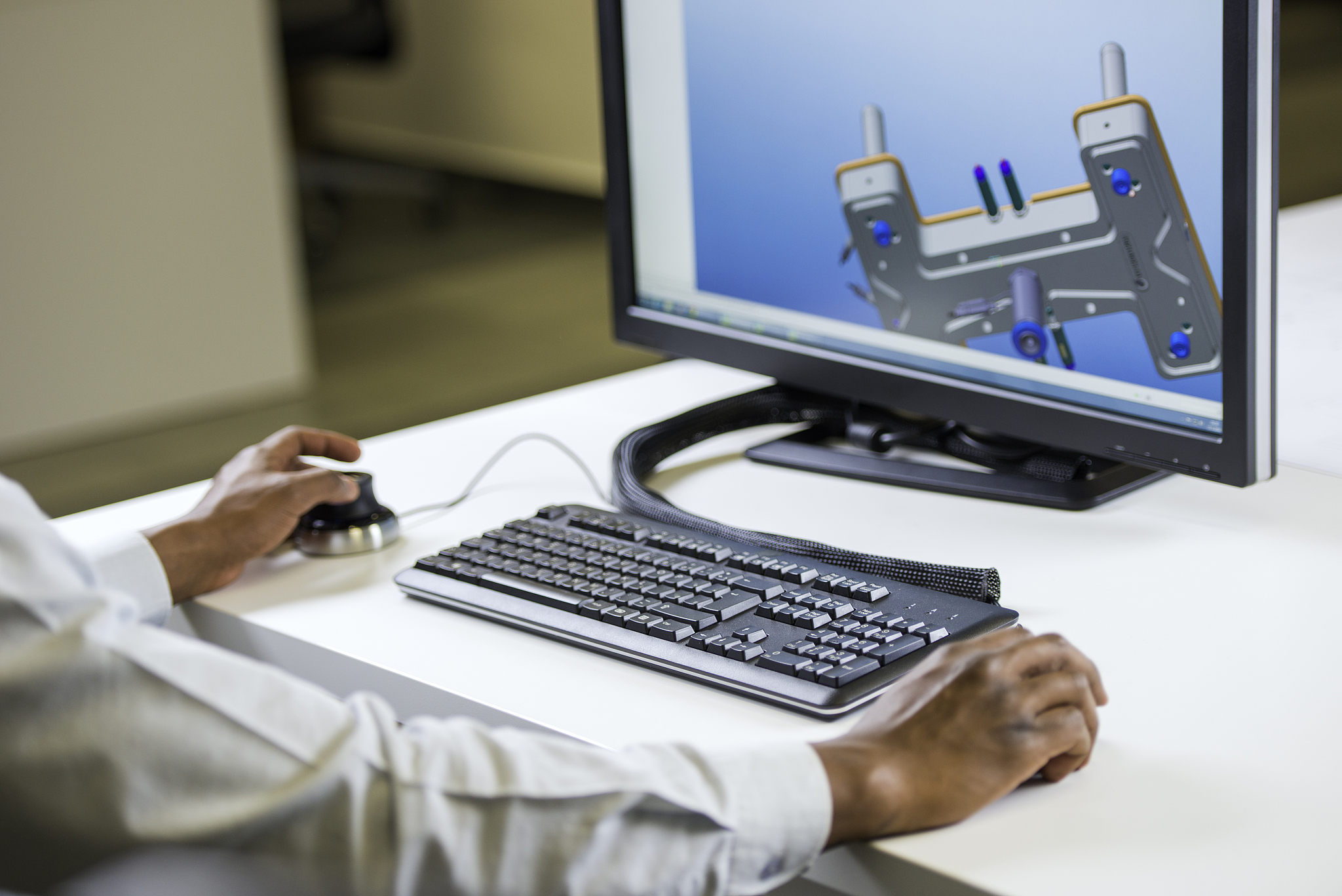 engineer's hands in front of computer monitor