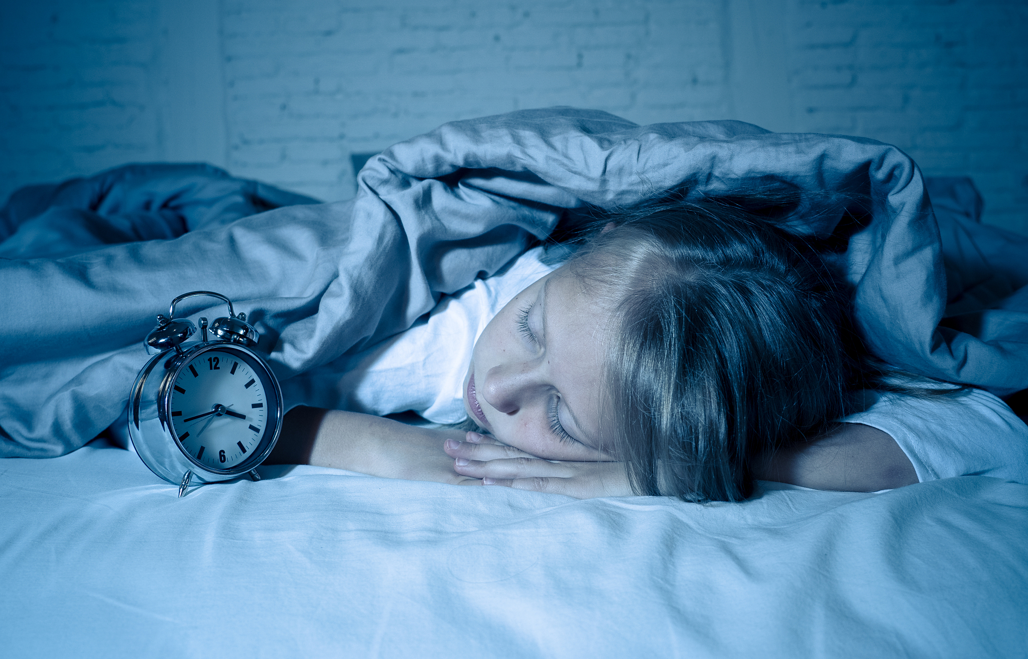 cute sleepless little girl lying in bed looking sad and tired ha