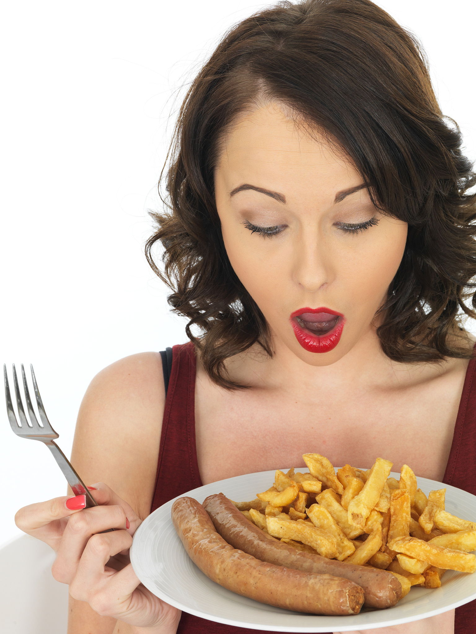 young woman with shocked expression eating jumbo sausage and chi
