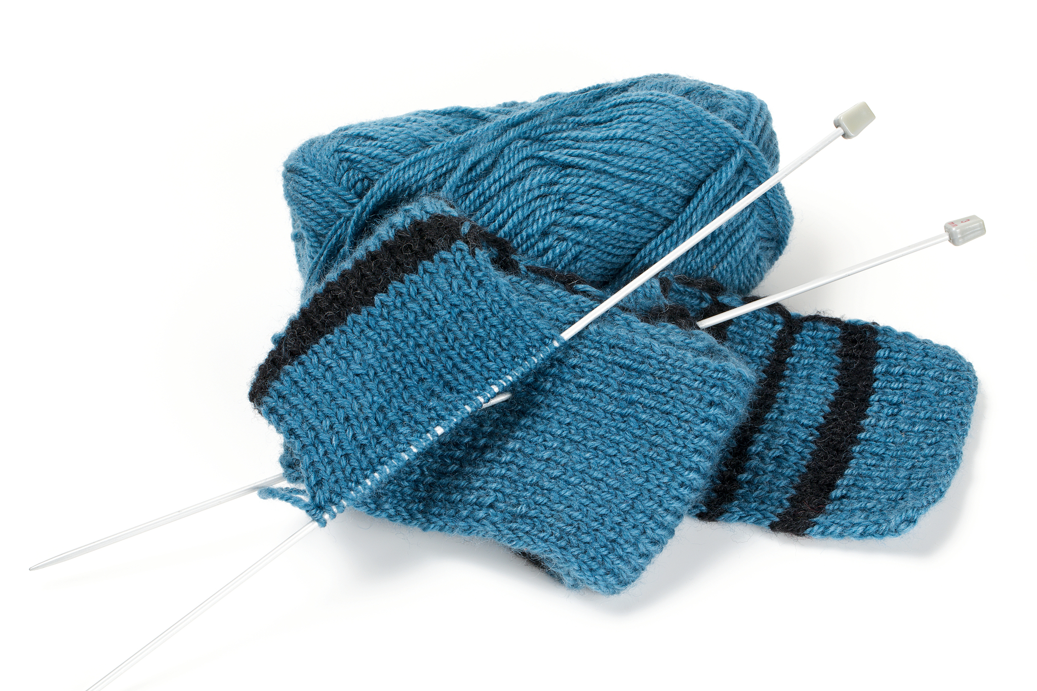 striped scarf on knitting needles