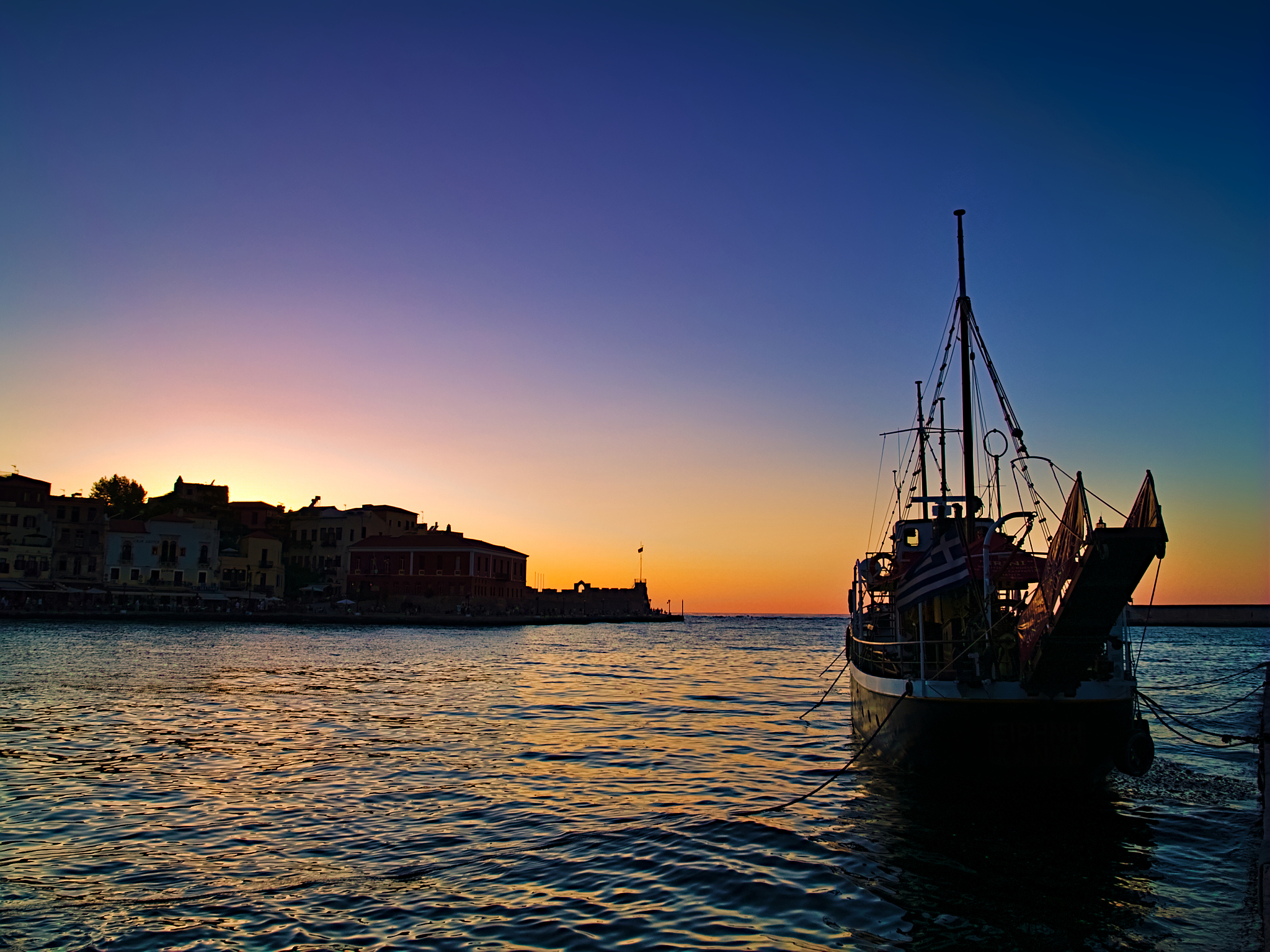sunset at the port of chania, crete, greece.