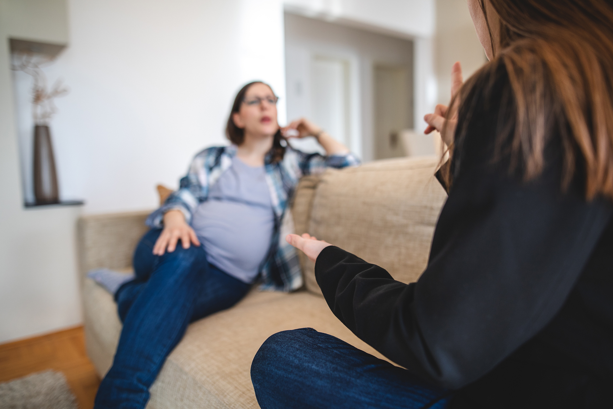 pregnant woman and her friend talking in hand signs
