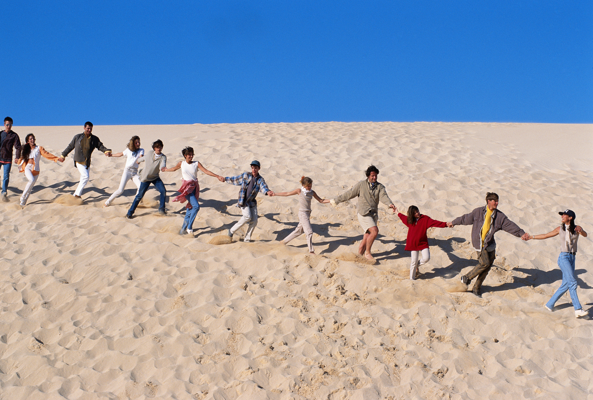 group of people running in desert