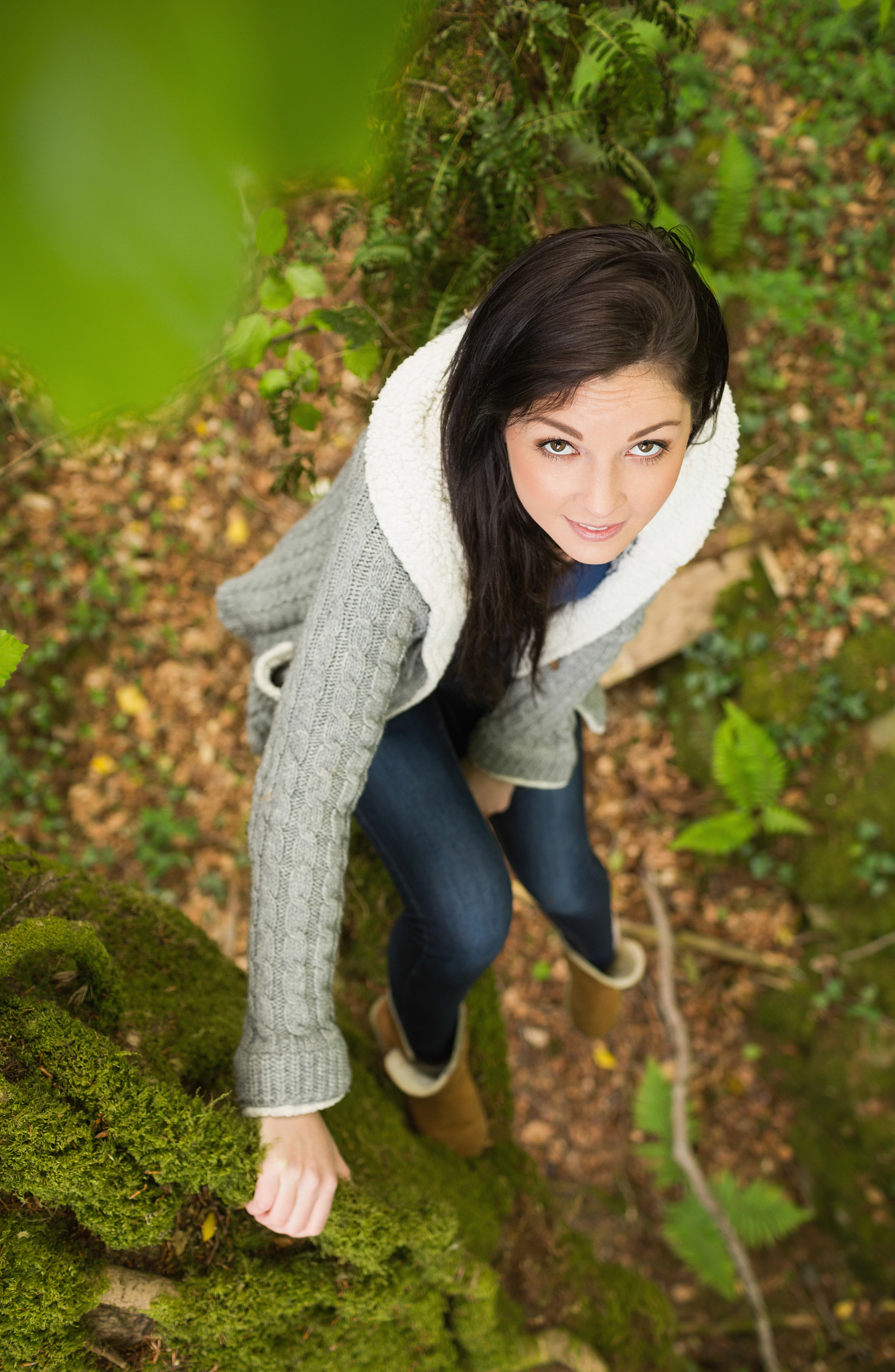 overhead of pretty brunette strolling in green forest