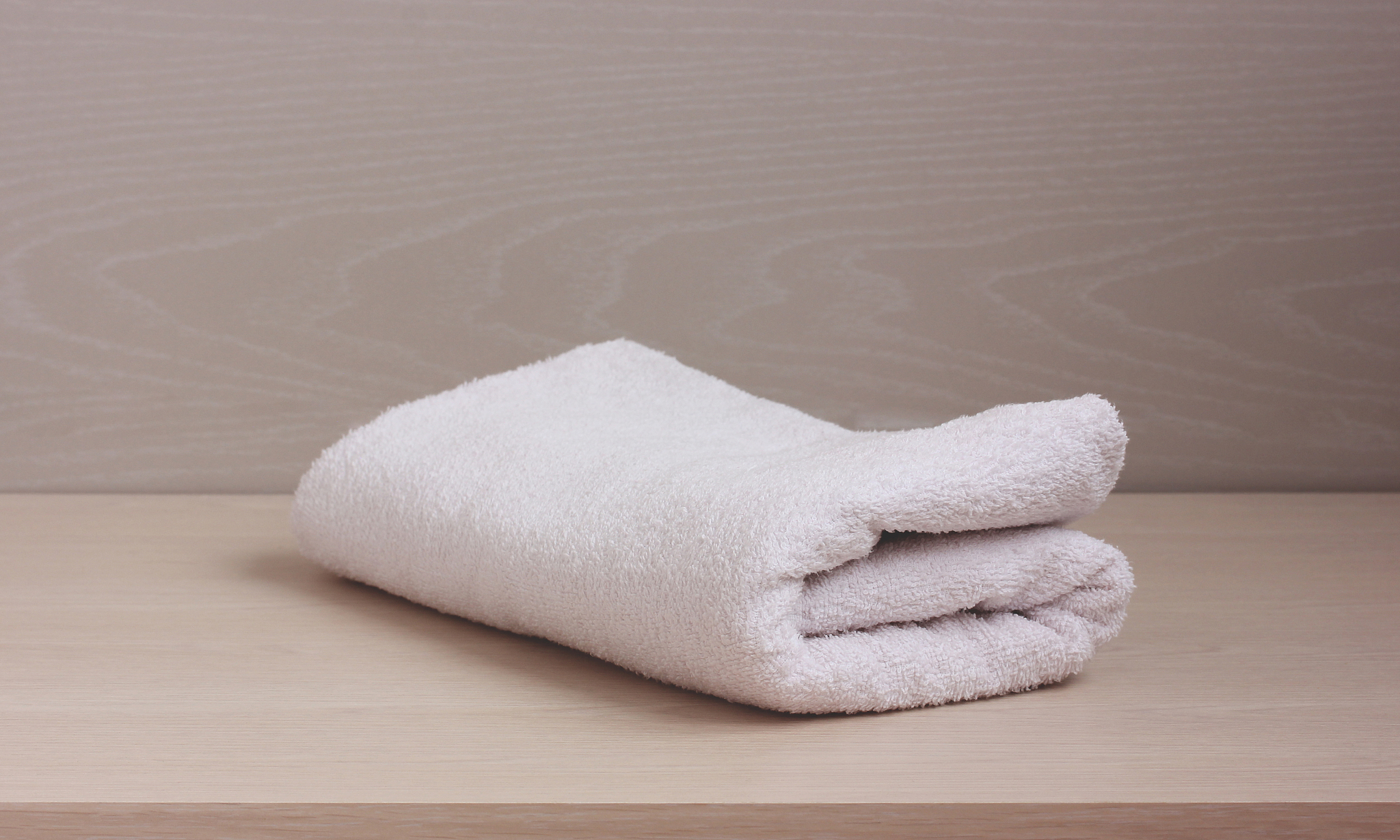folded white towel on the table.