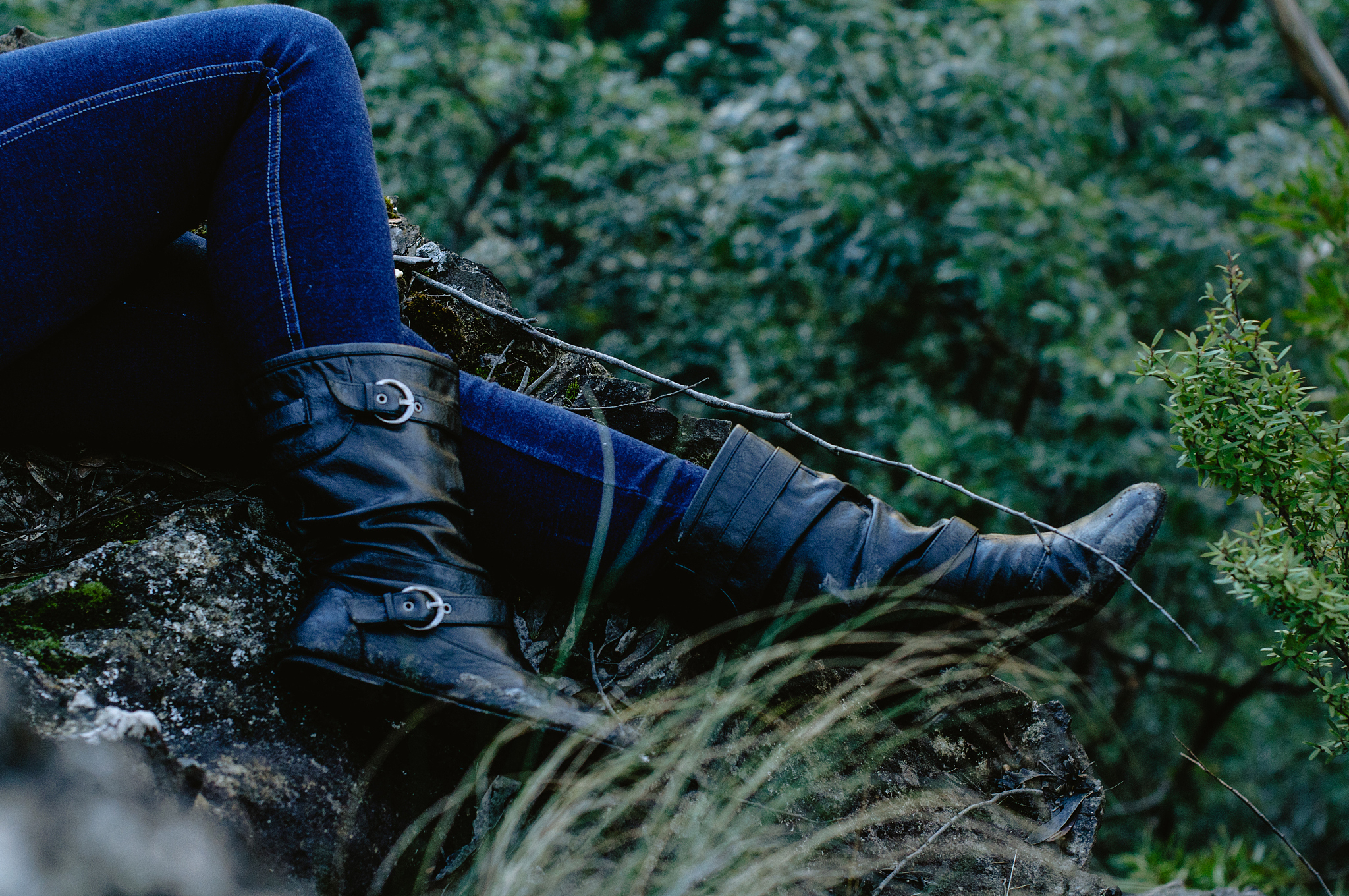 low section of young woman lying on cliff