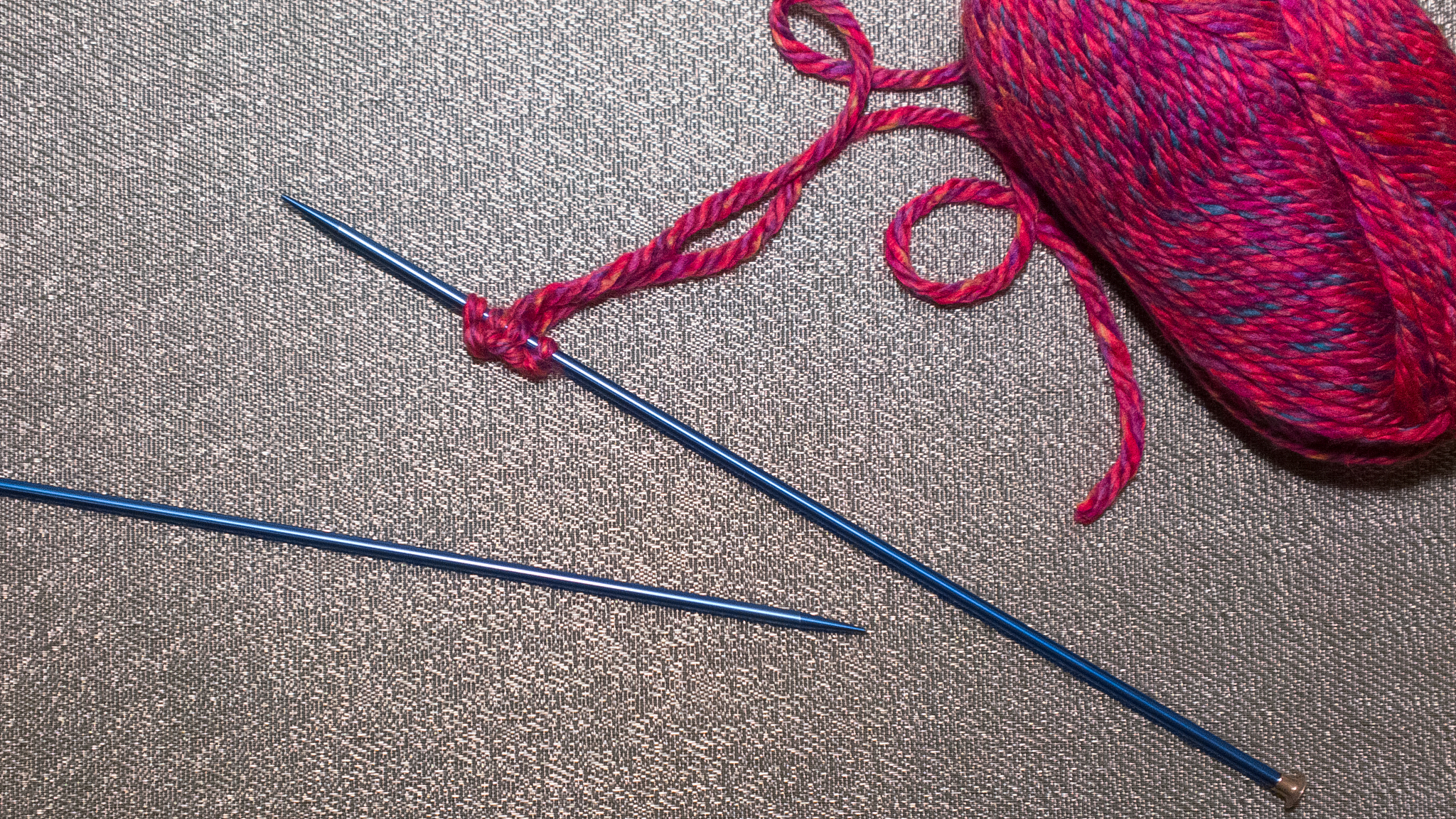 pink stitches on a knitting needle