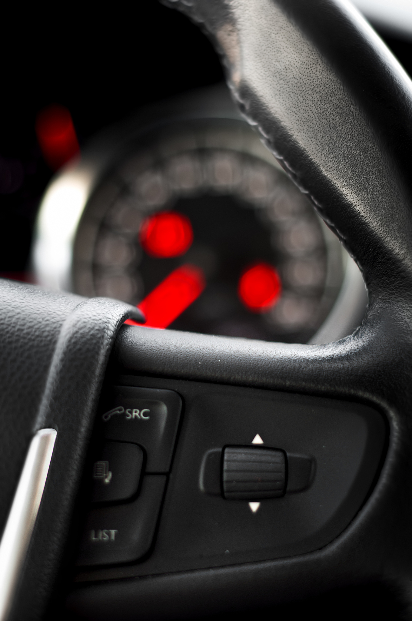 steering wheel comands with dashboard as background