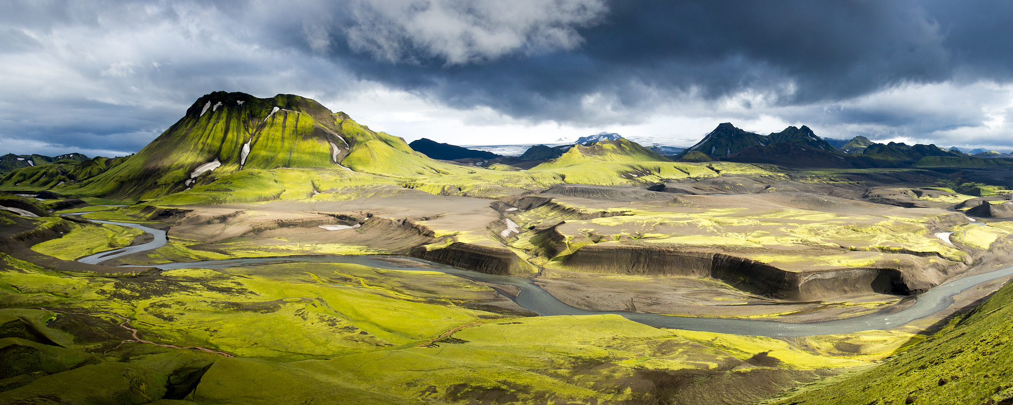 a river through a valley in iceland.