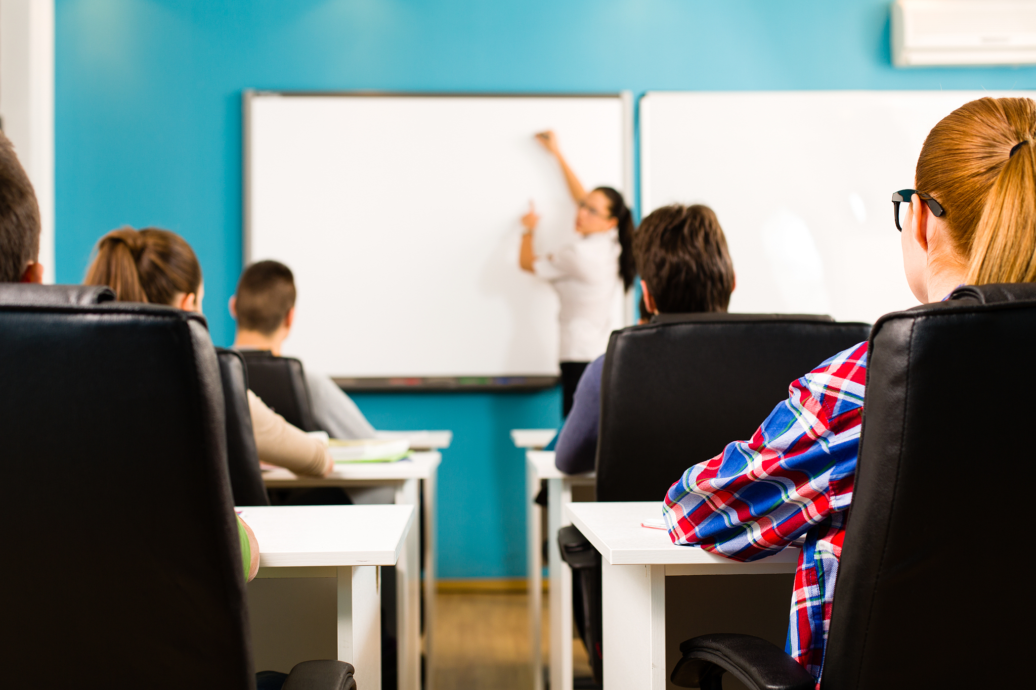 teacher writing on whiteboard