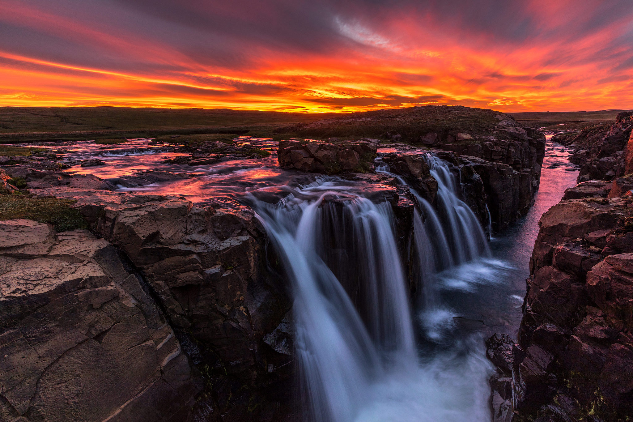 view of waterfalls at sunset
