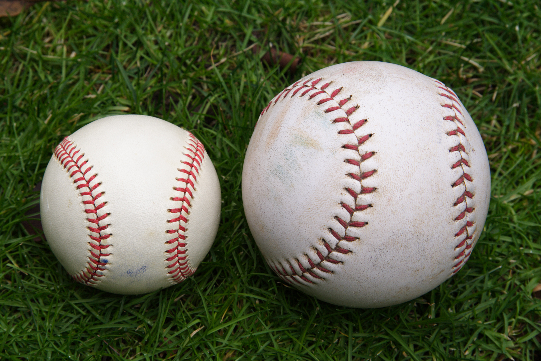 baseball and softball resting together