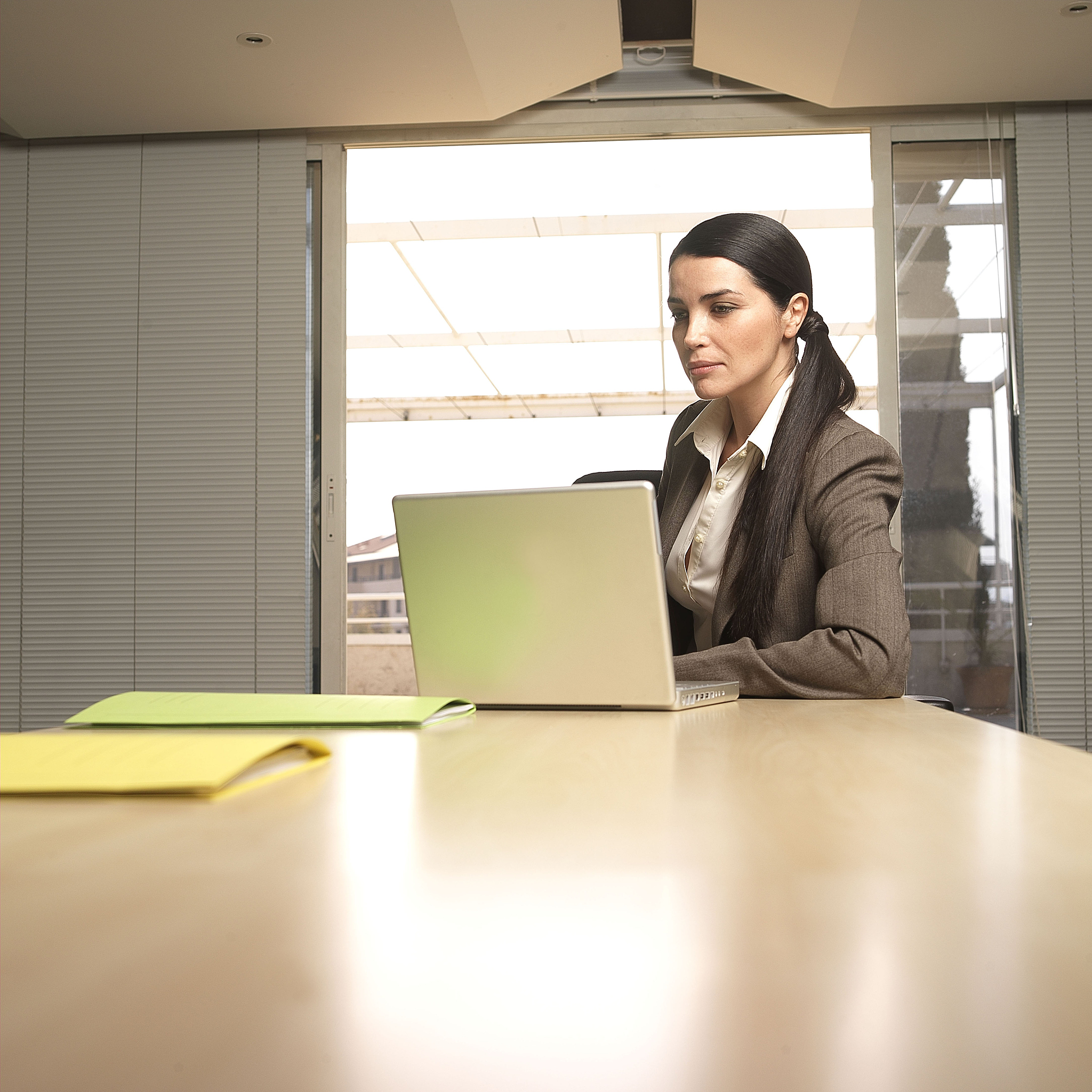 imagine prompt pretty woman computer office chair keyboard monitor concentration focus determination night dim light shadows atmosphere tension stress materials glass metal camera settings high-resolu
