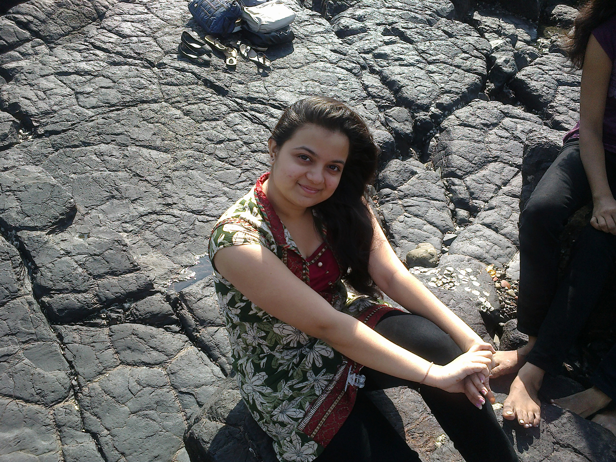 indian woman sitting at the coast