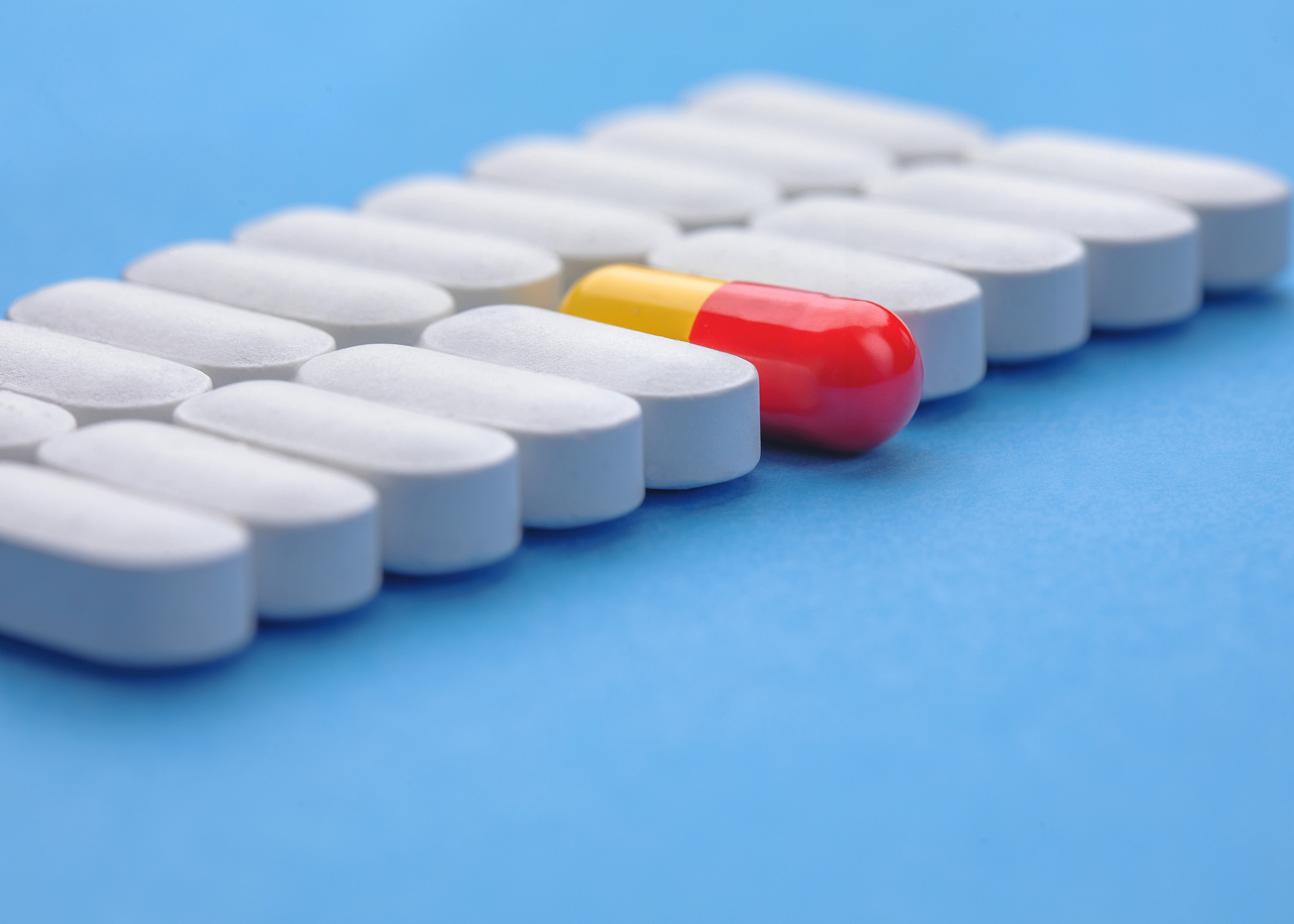 one red pill among white pills. concept of uniqueness