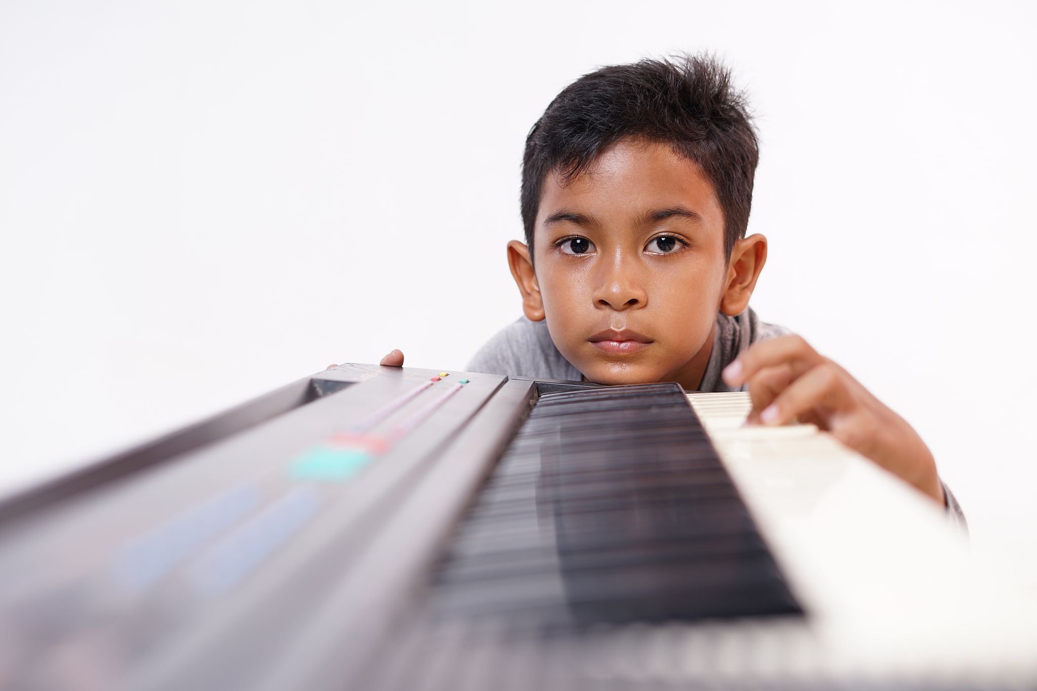 boring little boy with practising piano lesson