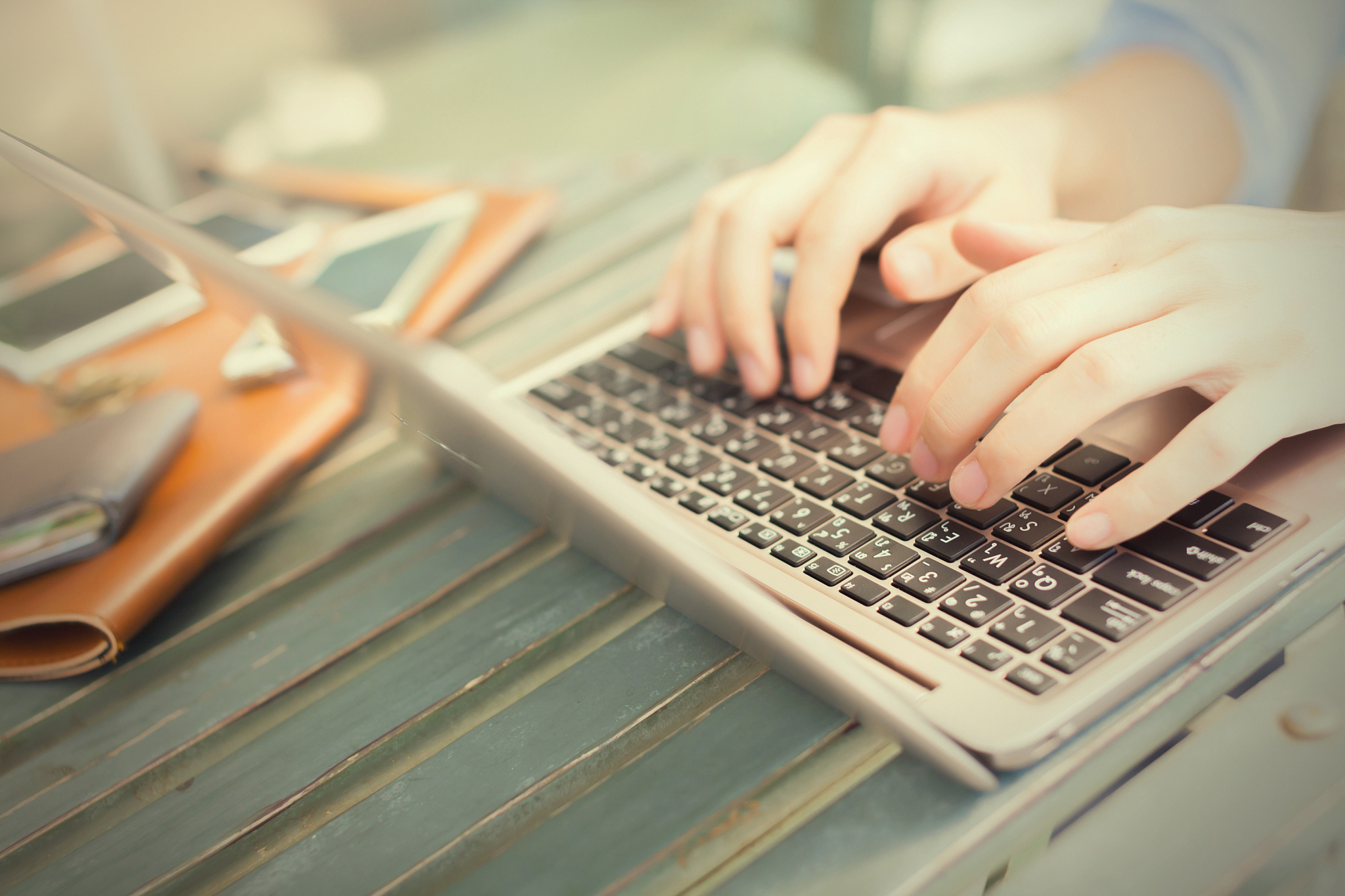 hands typing on laptop - work anywhere concept (selective focus)
