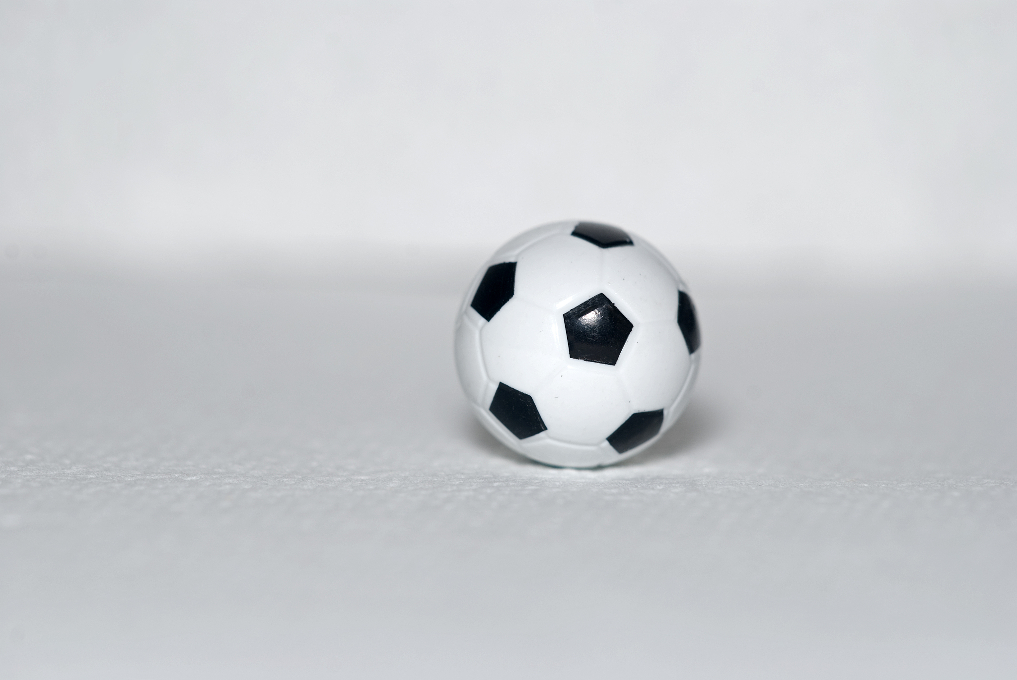 small toy, plastic soccer ball on a white background