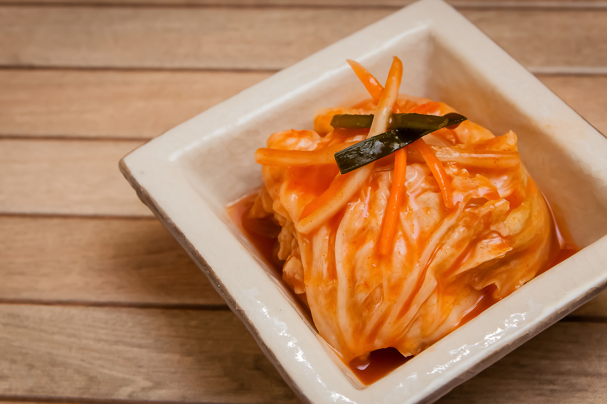chinese cabbage kimchi on wooden plate stock photo