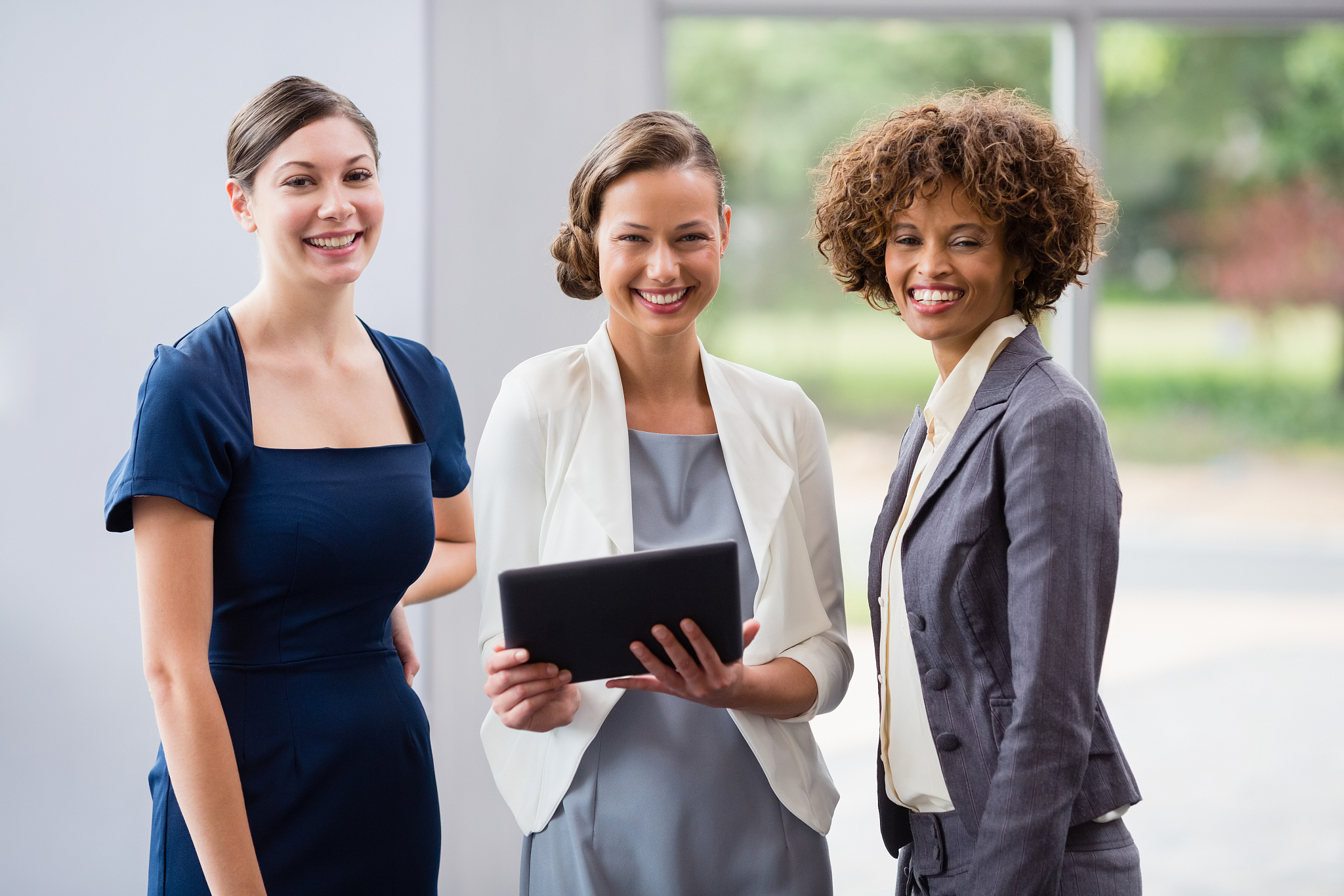 business executives holding digital tablet