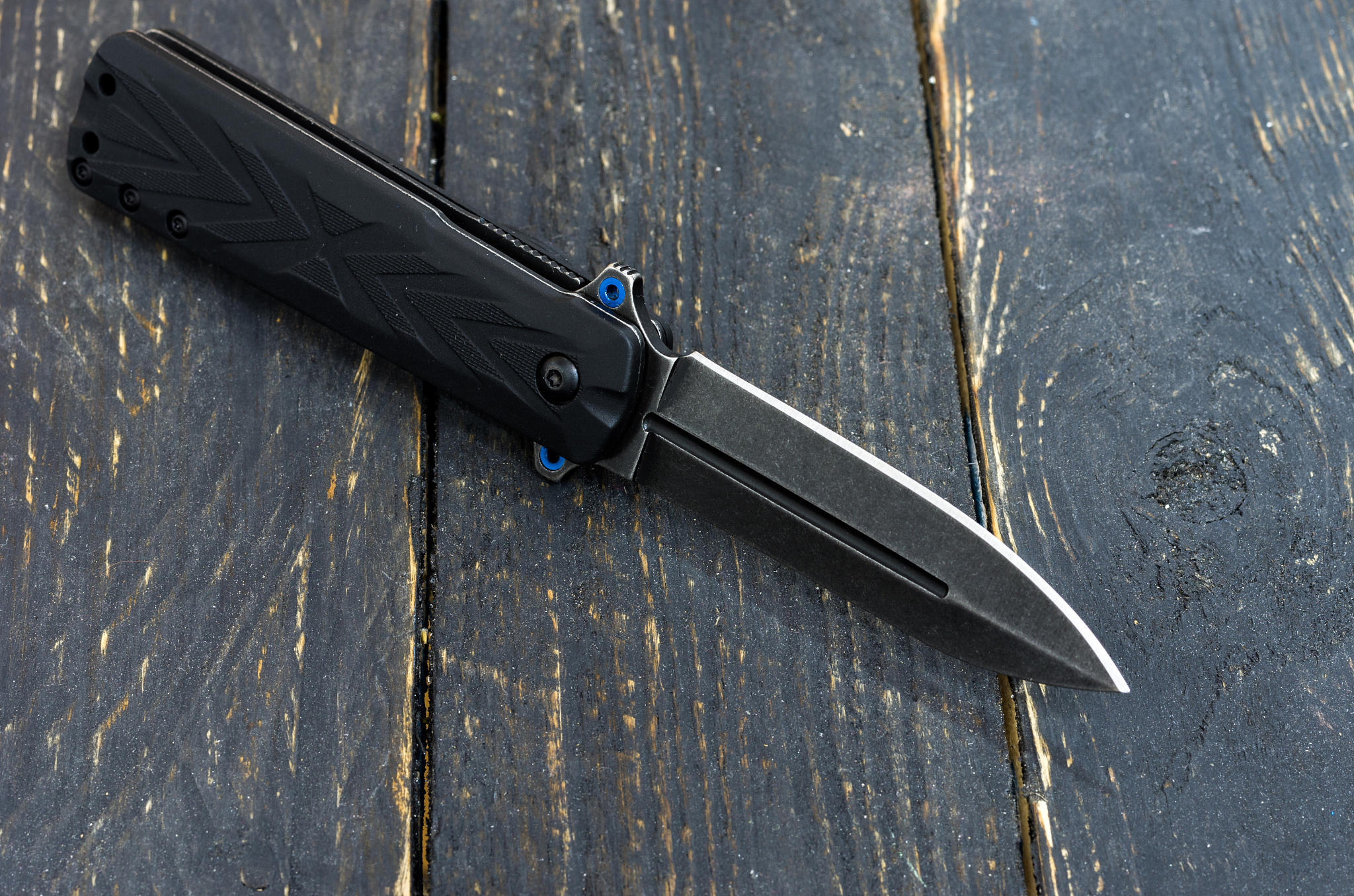 black knife wooden background. black texture.