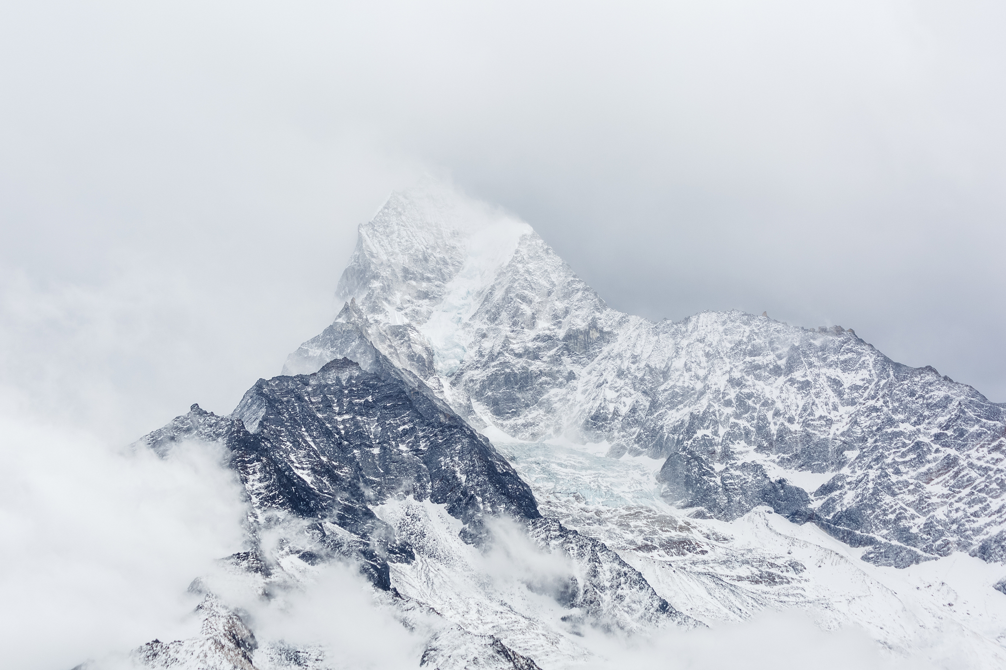 mountains of nepal covered with clouds.