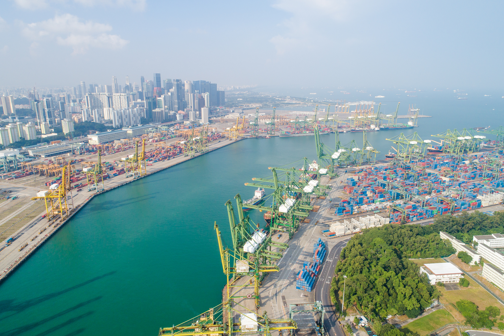 container cargo freight ship with working crane bridge in shipya