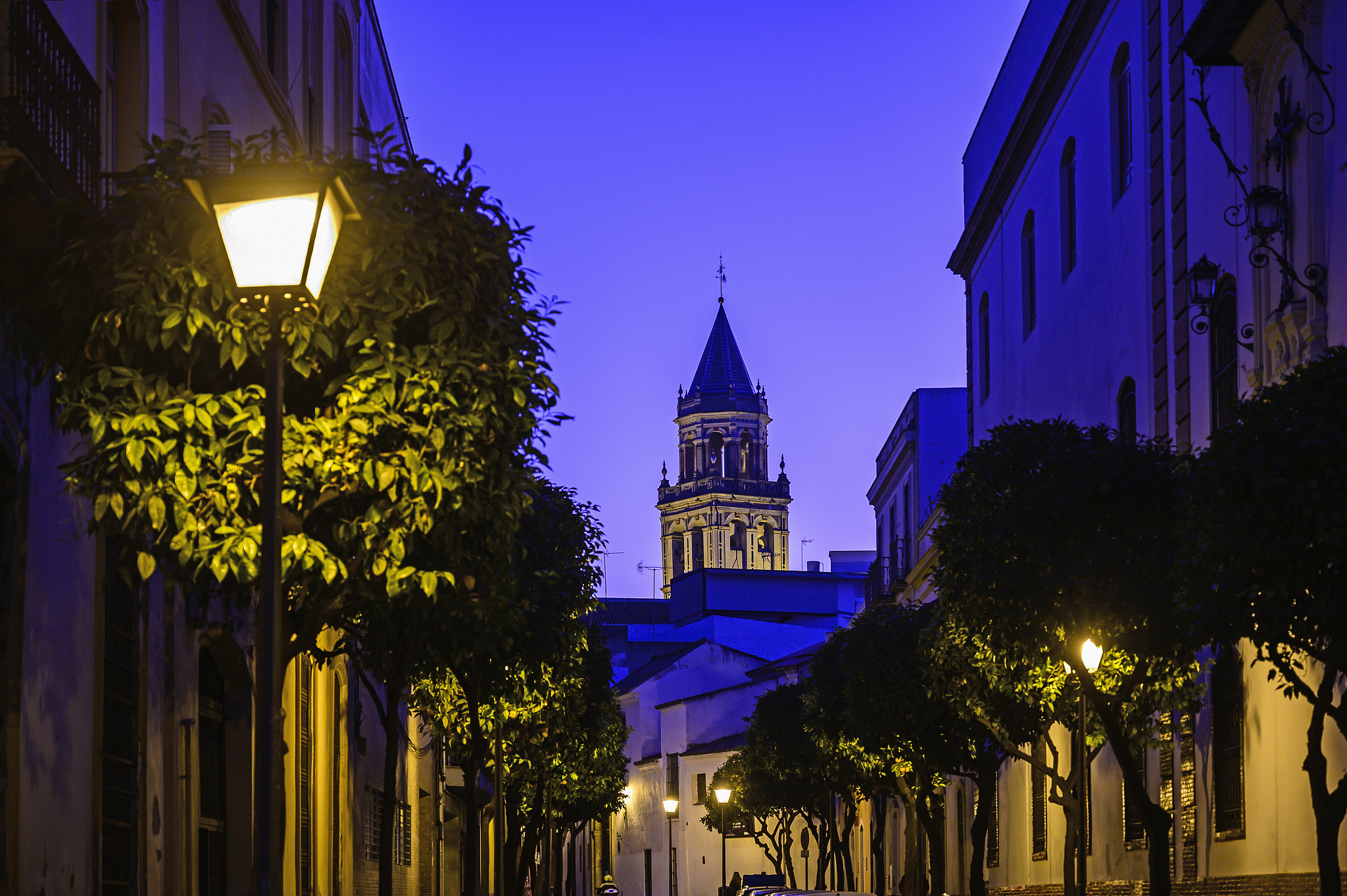 spain, andalusia, seville, old town street at dusk