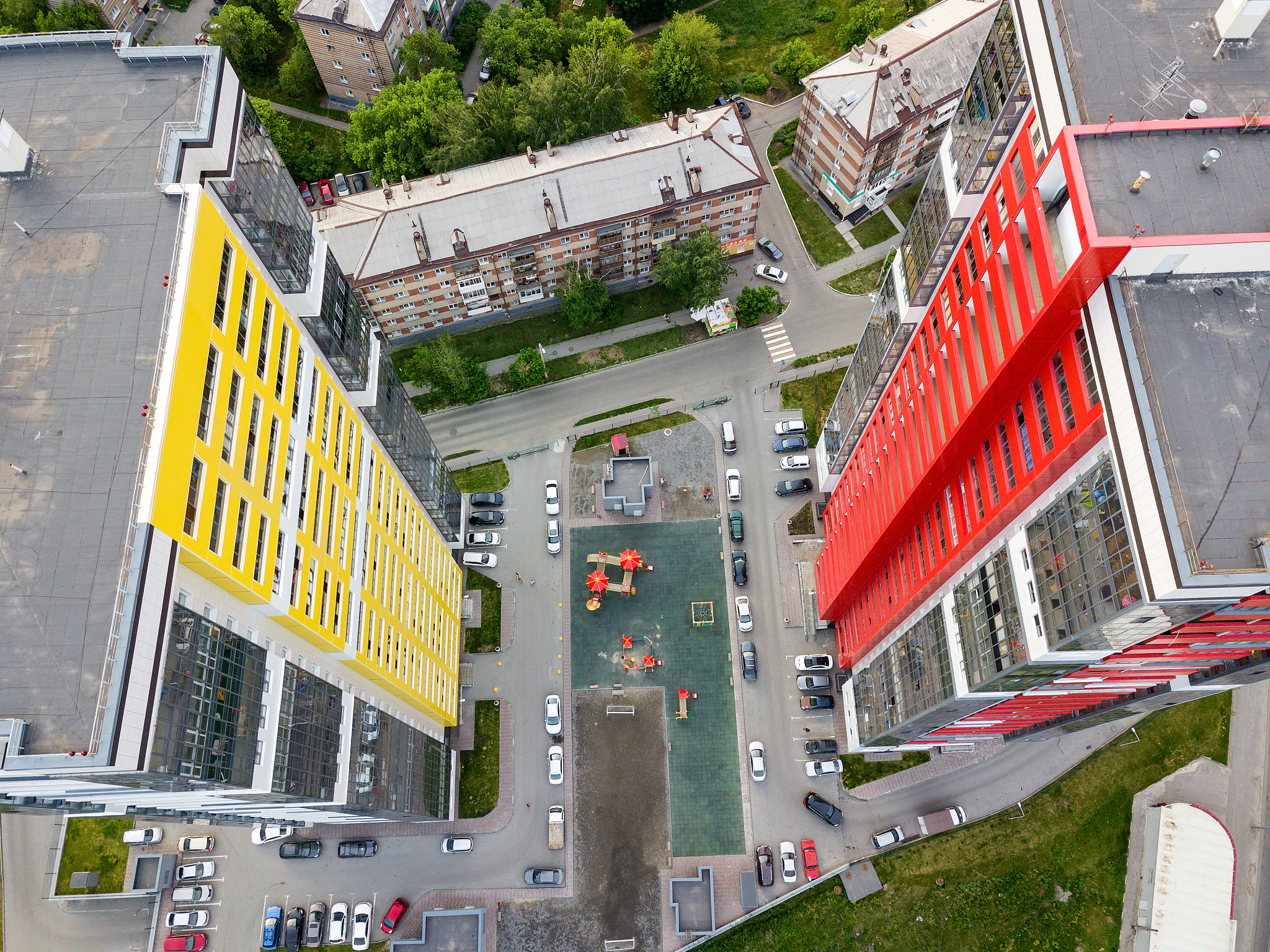 aerial view between of two tall skyscrapers of red and yellow co
