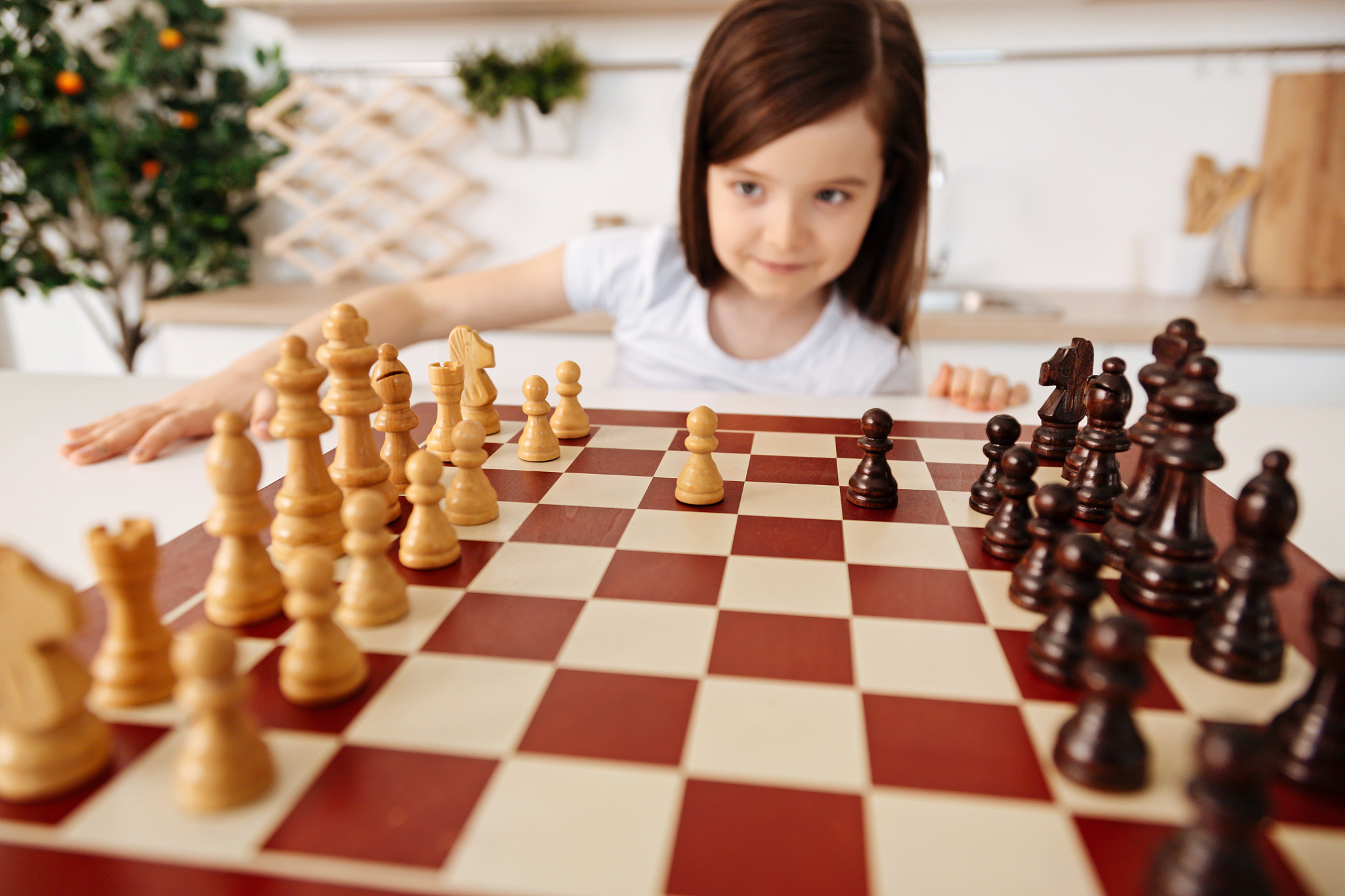 little girl changing a perspective on a chessboard
