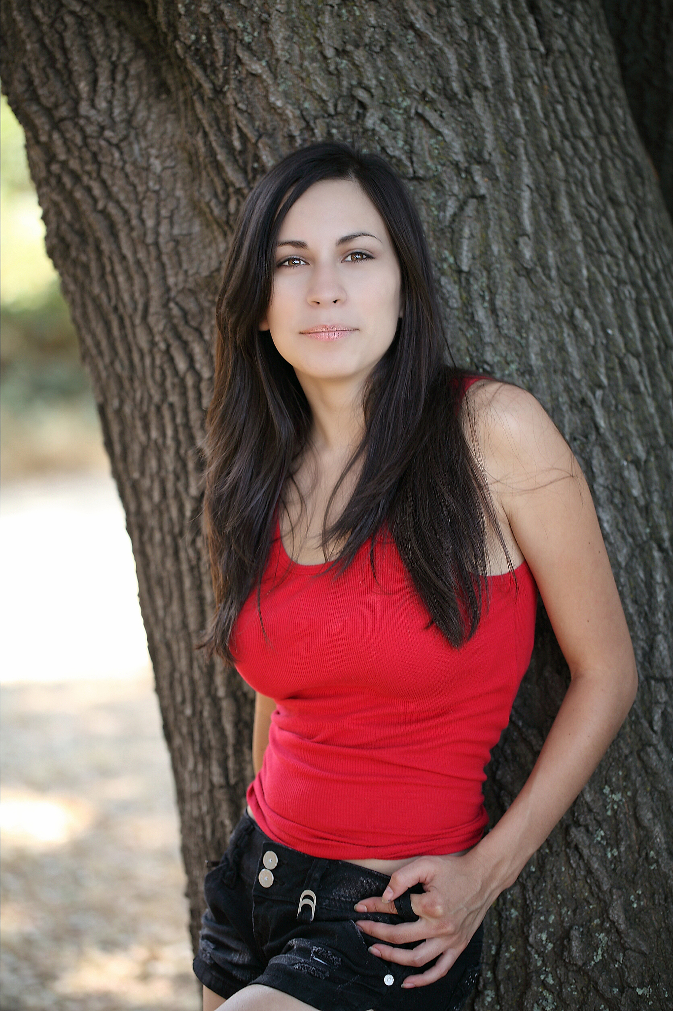 young hispanic teen girl outdoor portrait with tree