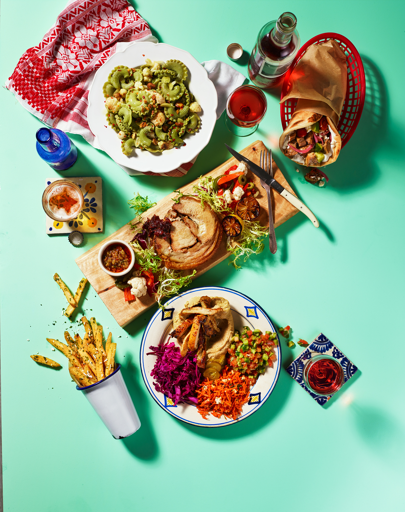 potluck dinner with gyro, pasta, pork roulade, french fries