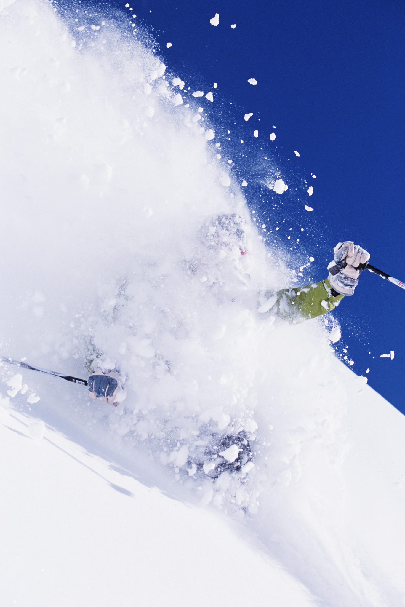 male skier skiing through snow cloud, close-up