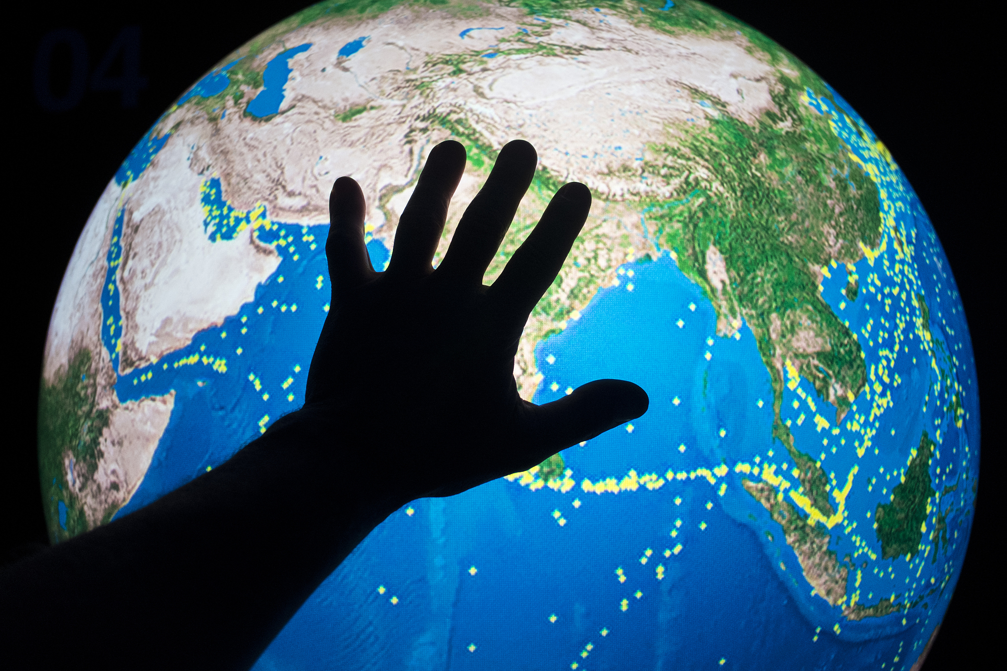 hand on world map