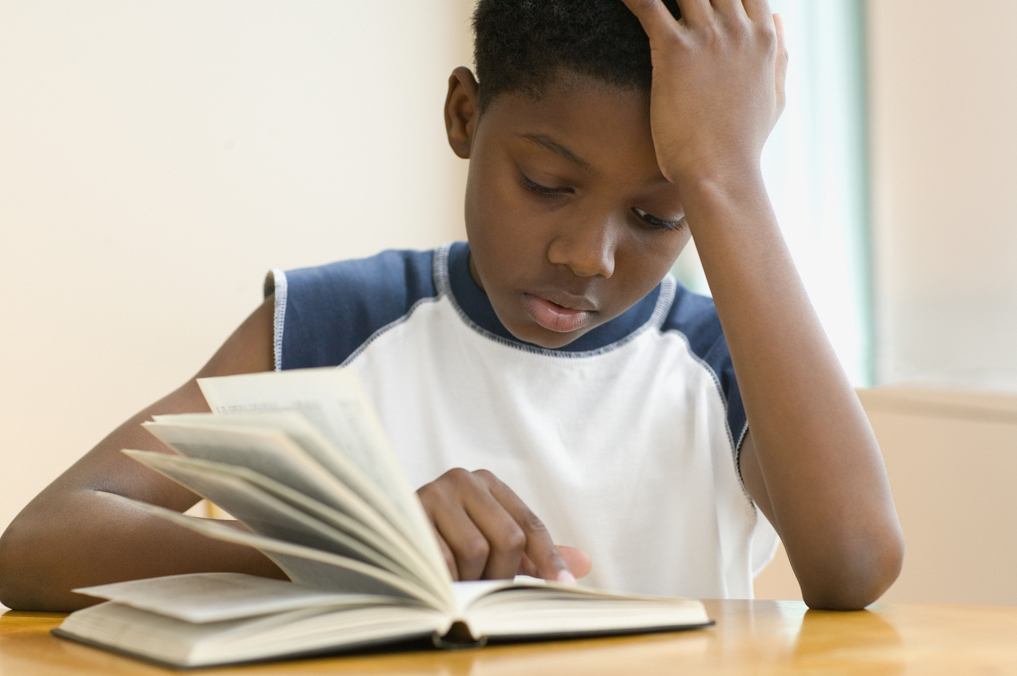 african american boy reading book