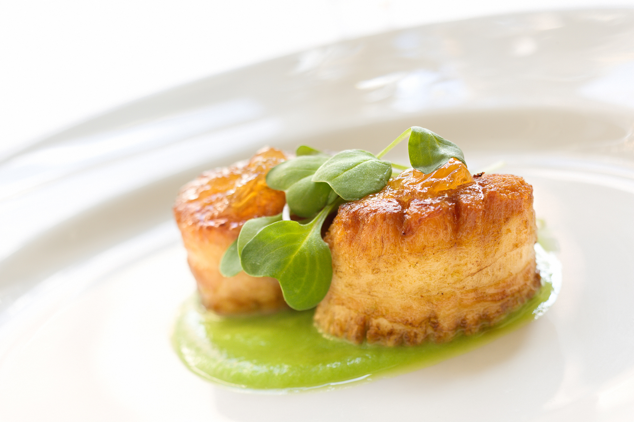 jumbo scallops wrapped in prosciutto over a fava bean puree